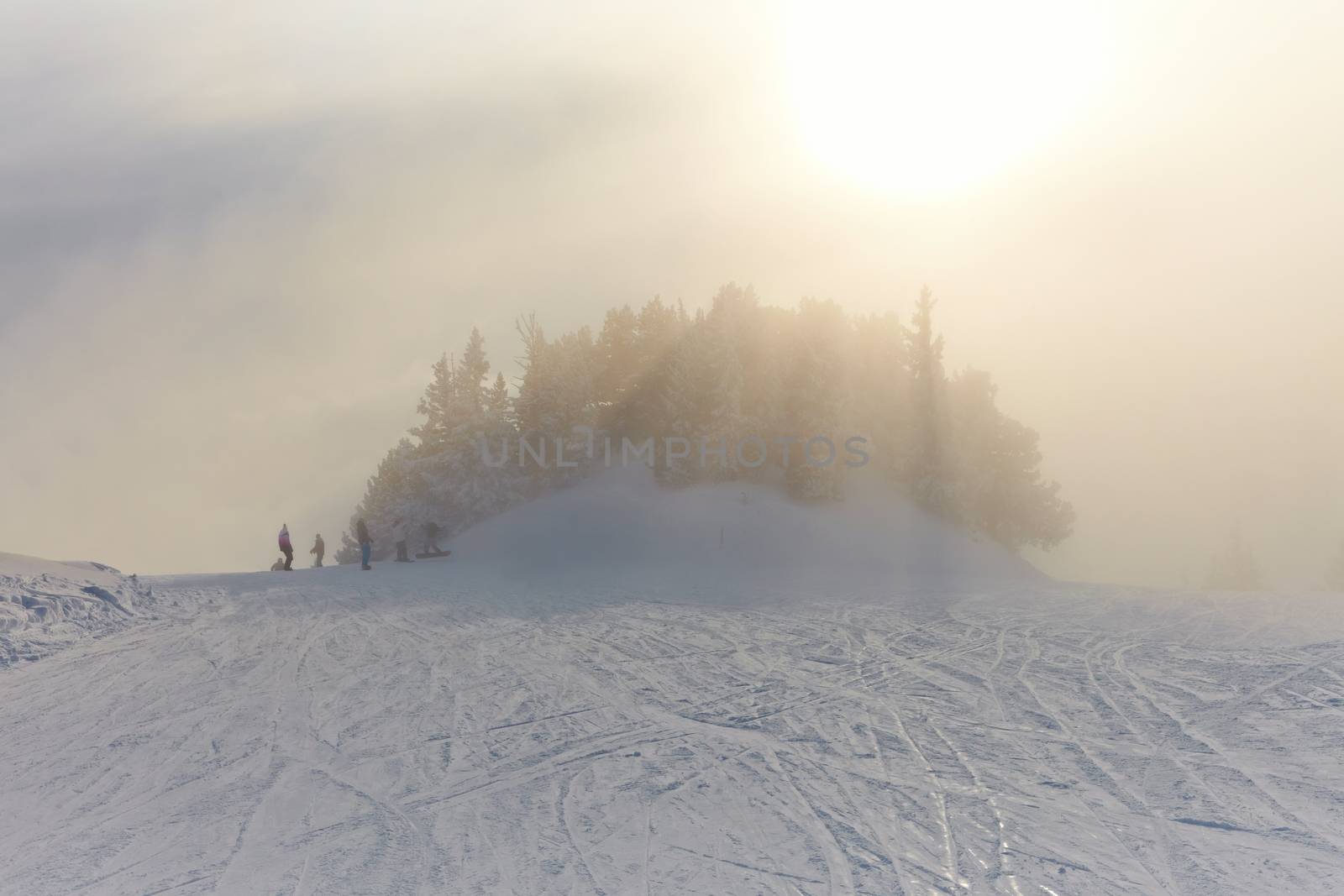 Foggy winter landscape with skiing slope