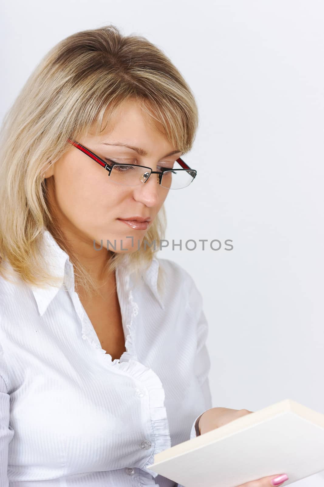 Portrait of an attractive blonde with a book