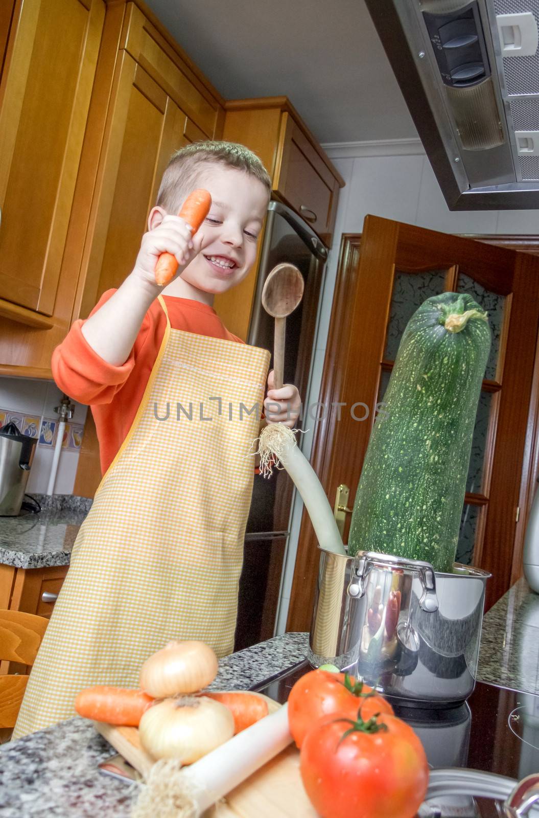 Cute child chef cooking big zucchini in a pot by doble.d