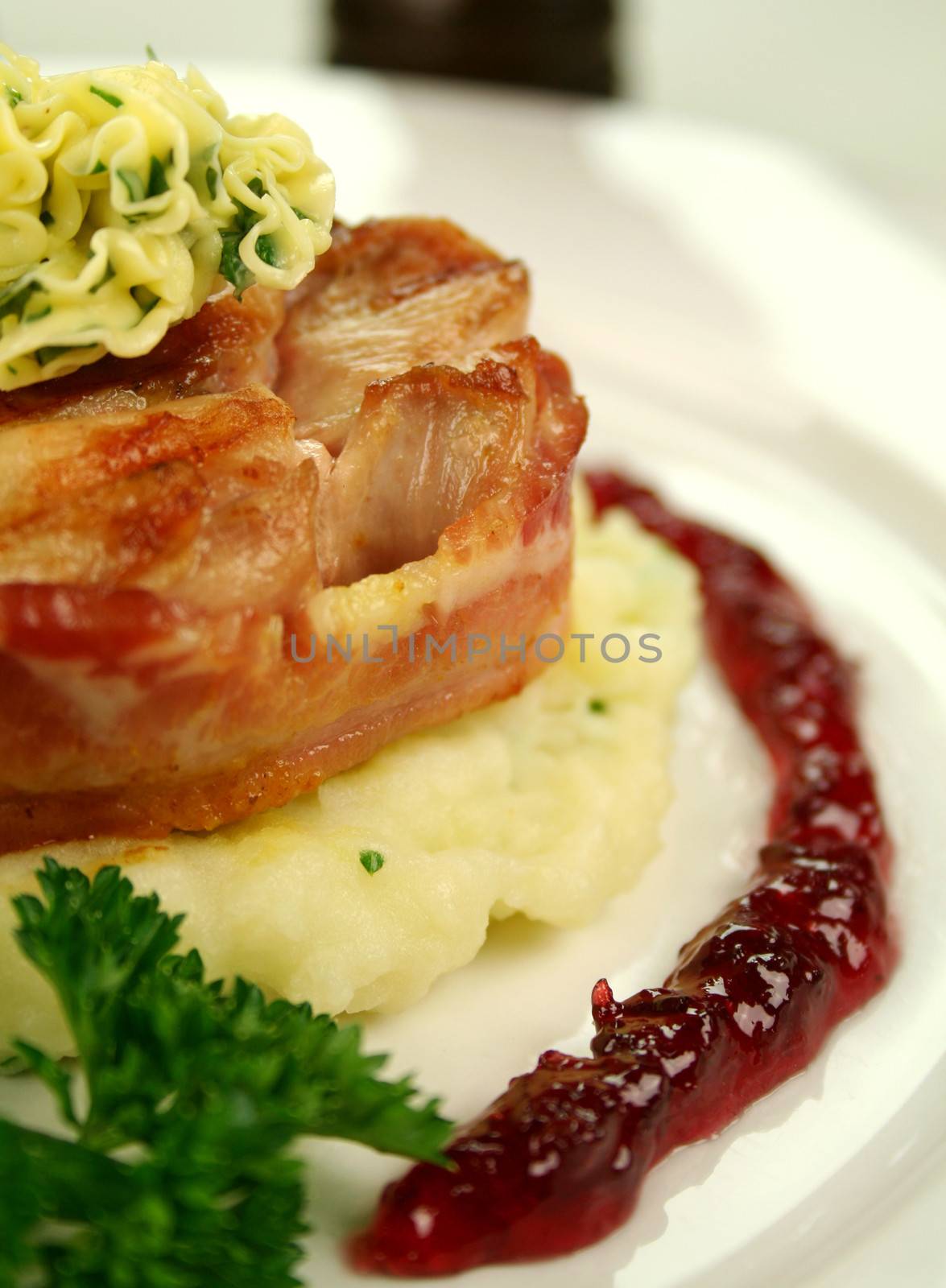 Chicken fillet mignon on parsley mashed potato with a red wine and raspberry jus.