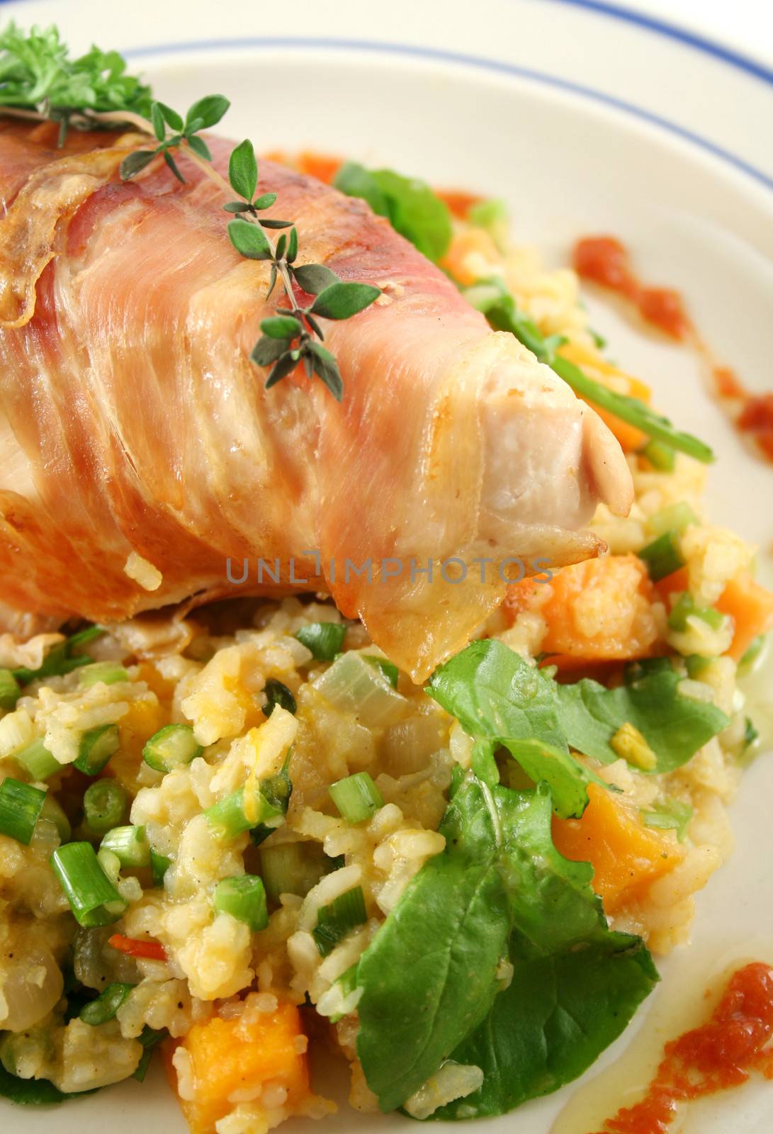 Chicken wrapped in prosciutto on pumpkin and rocket risotto.