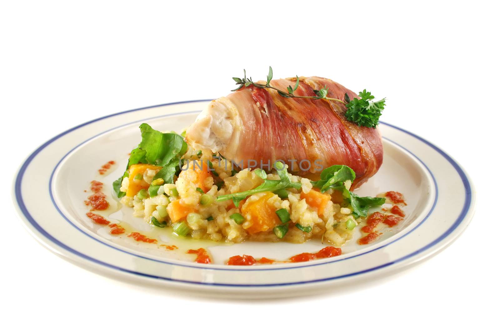 Chicken wrapped in prosciutto on pumpkin and rocket risotto.