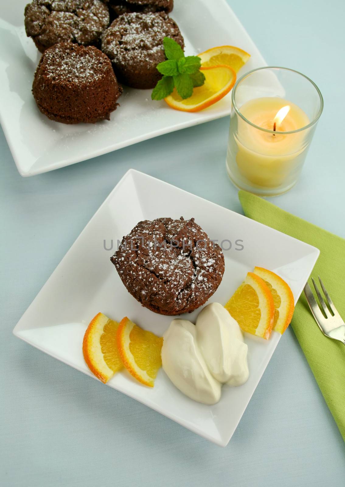 Chocolate brownies with orange and whipped cream ready to serve.