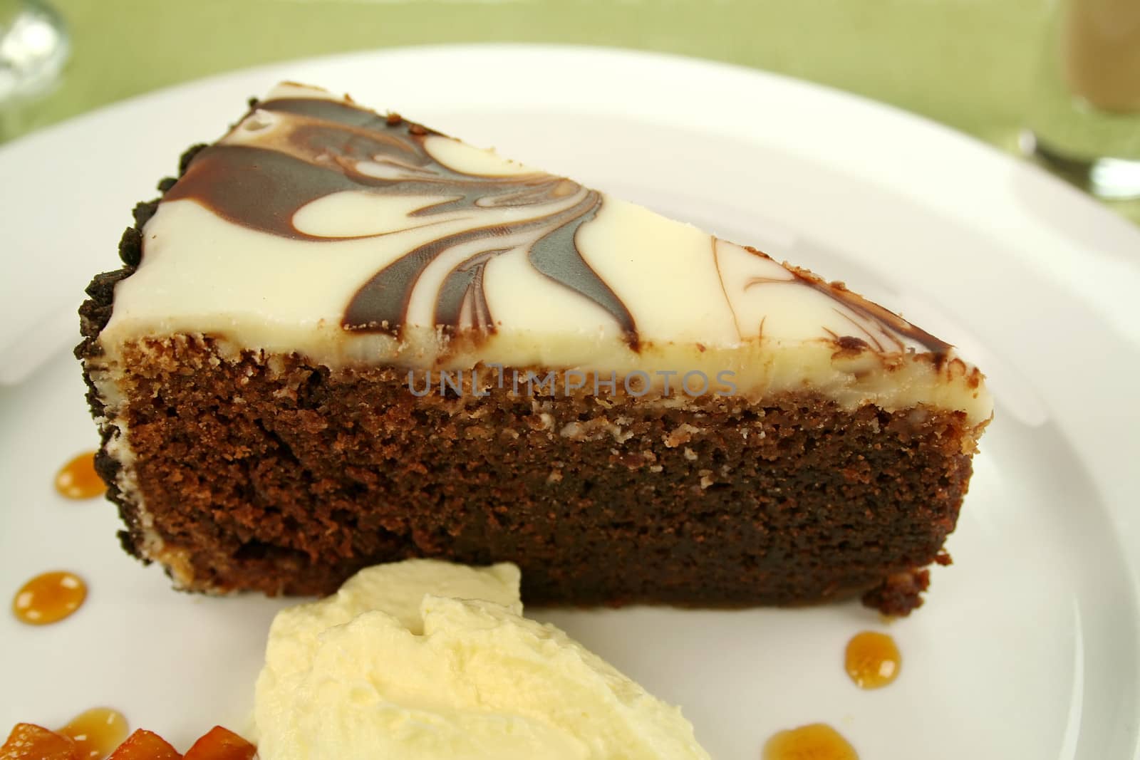 Rich chocolate cake with orange toffee and cream with a mint garnish.