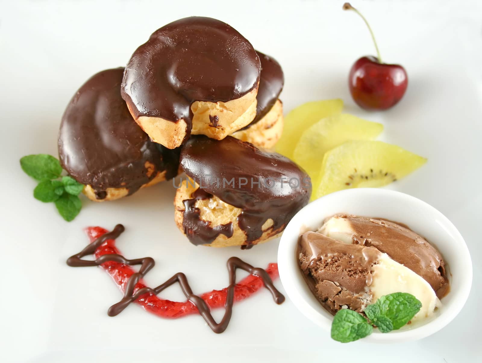 Chocolate profiteroles with kiwi fruit and ice cream.