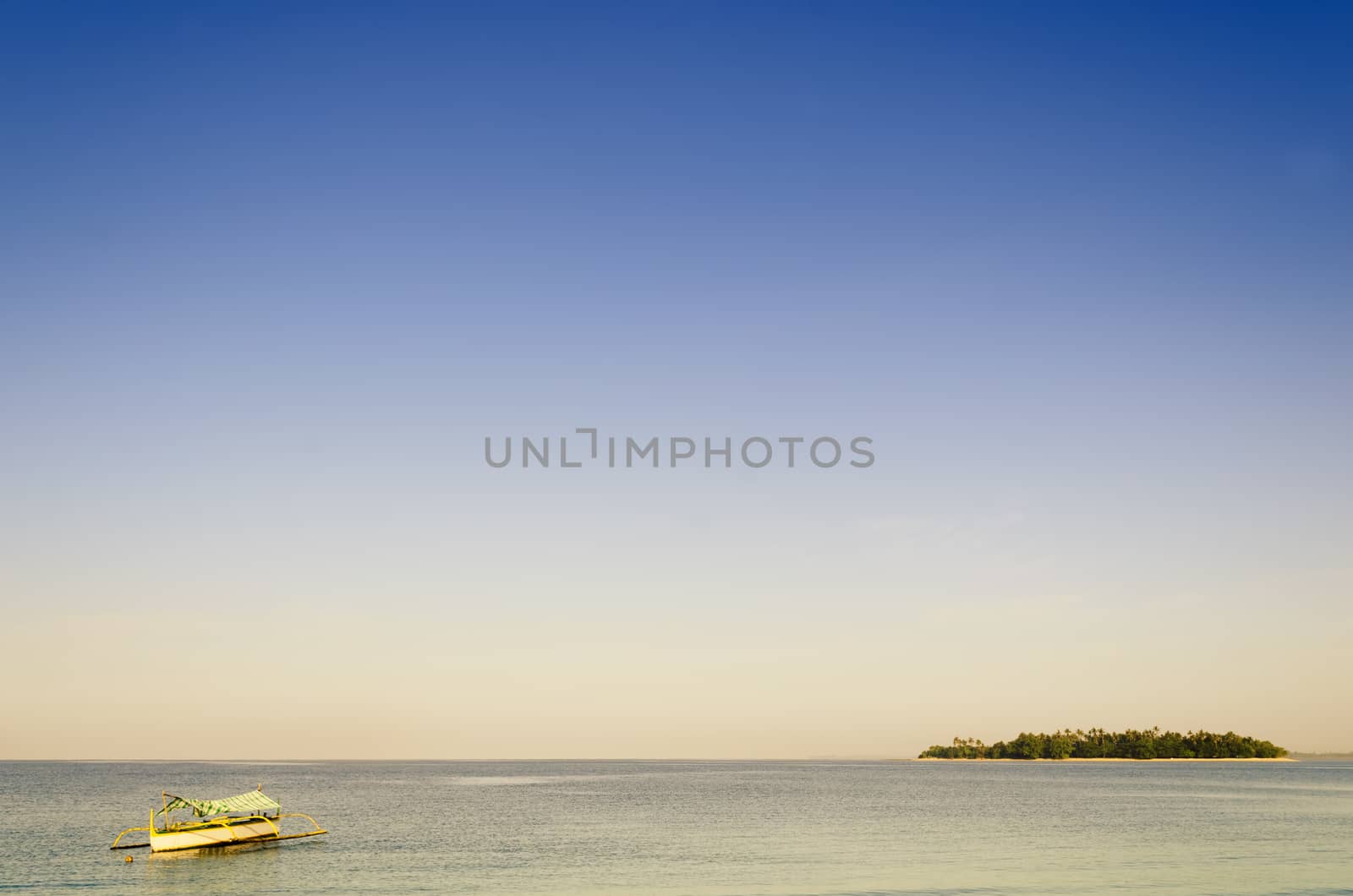 Outrigger off the coast of a tiny tropical island in the Philippines