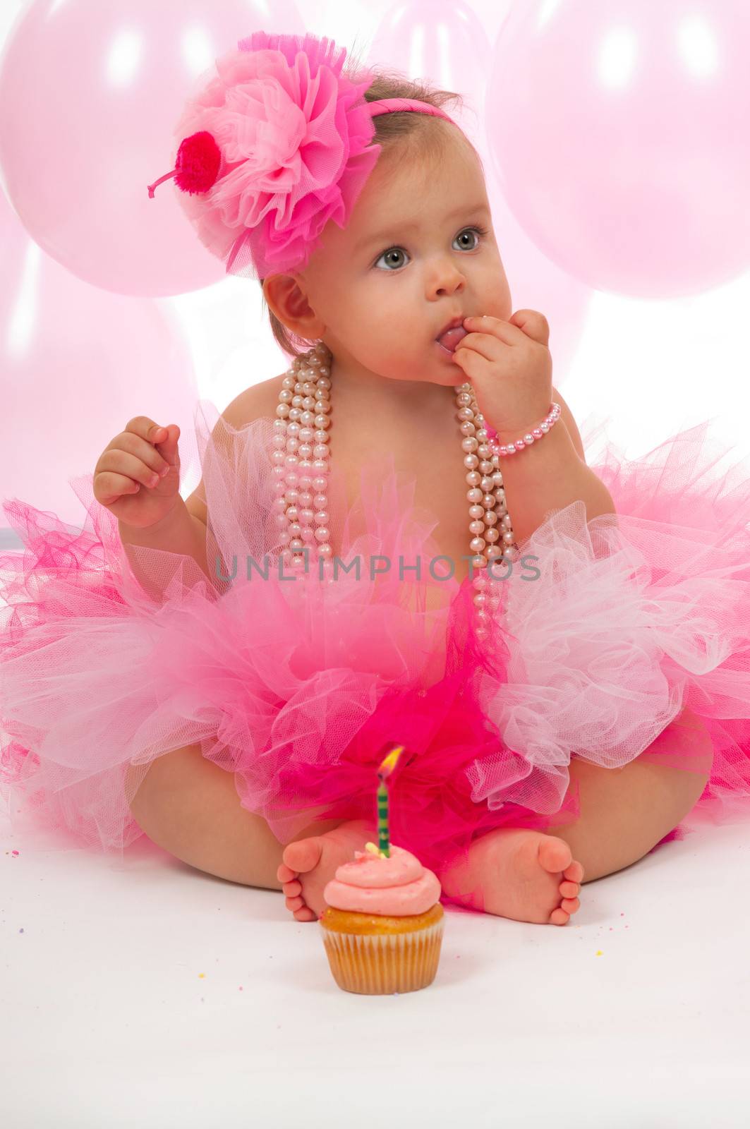 Birthday baby eating her cake