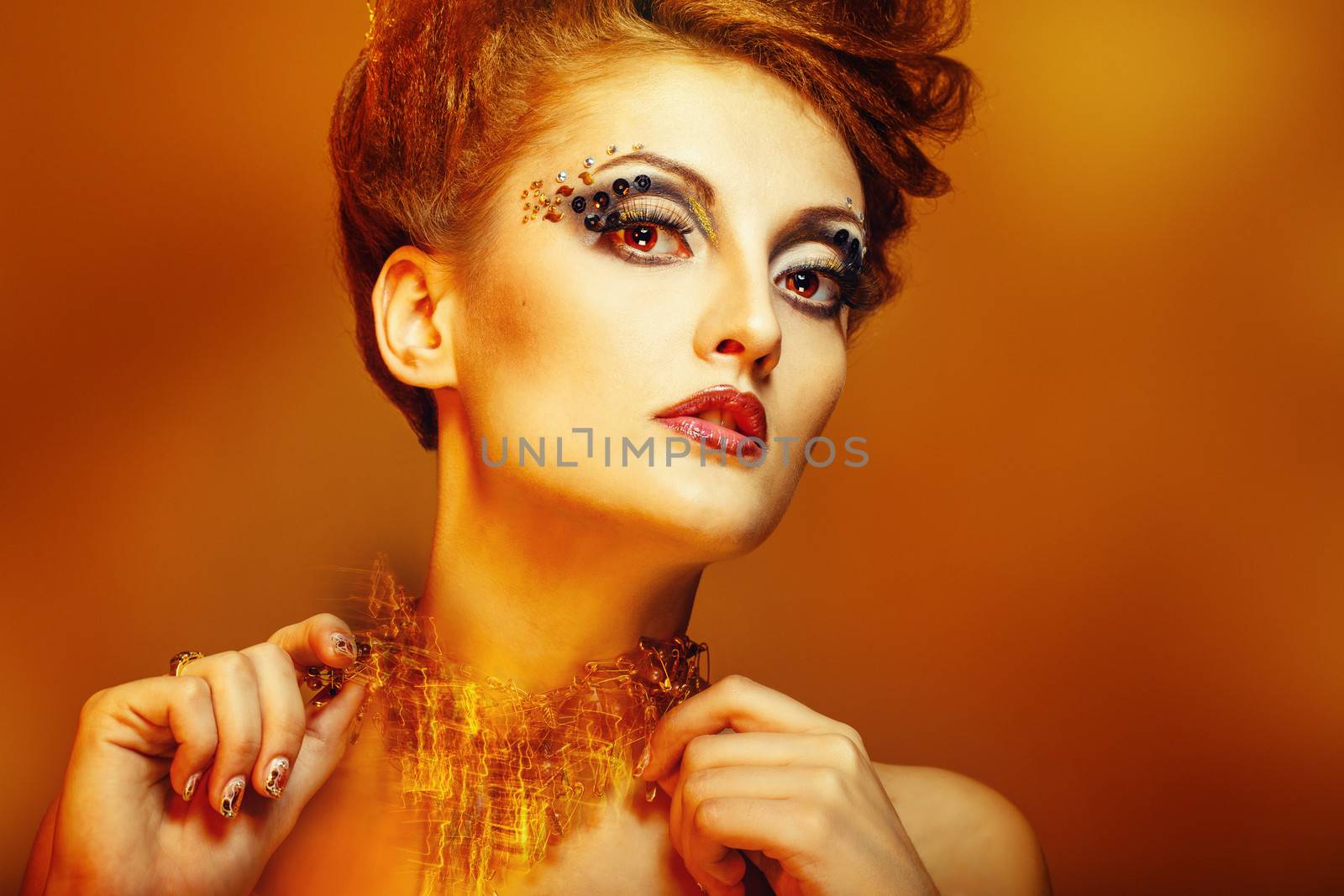 Close-up portrait of a young and attractive girl with hairstyle and jewelry, nail art design