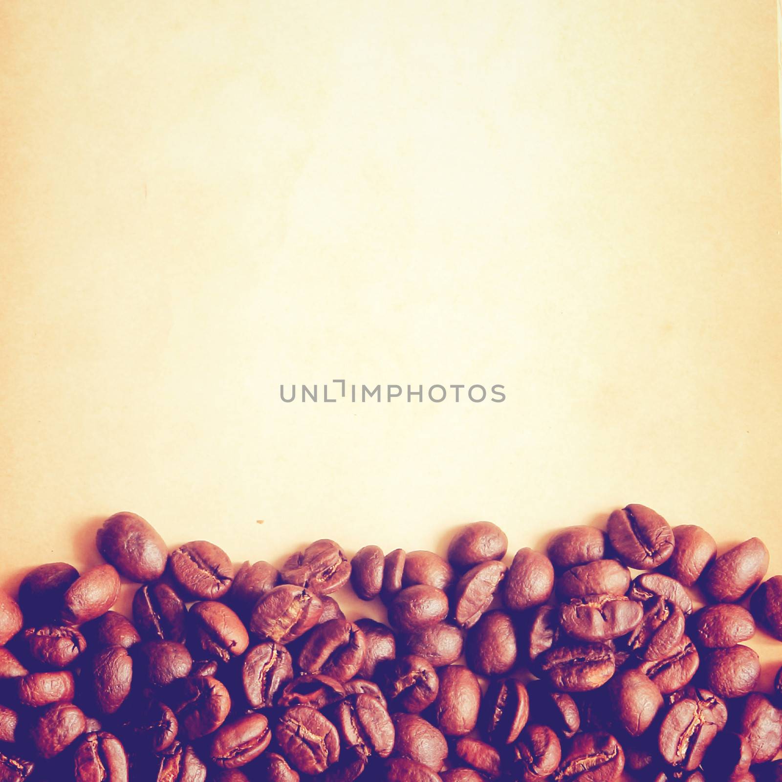 Coffee beans on old paper background with retro filter effect