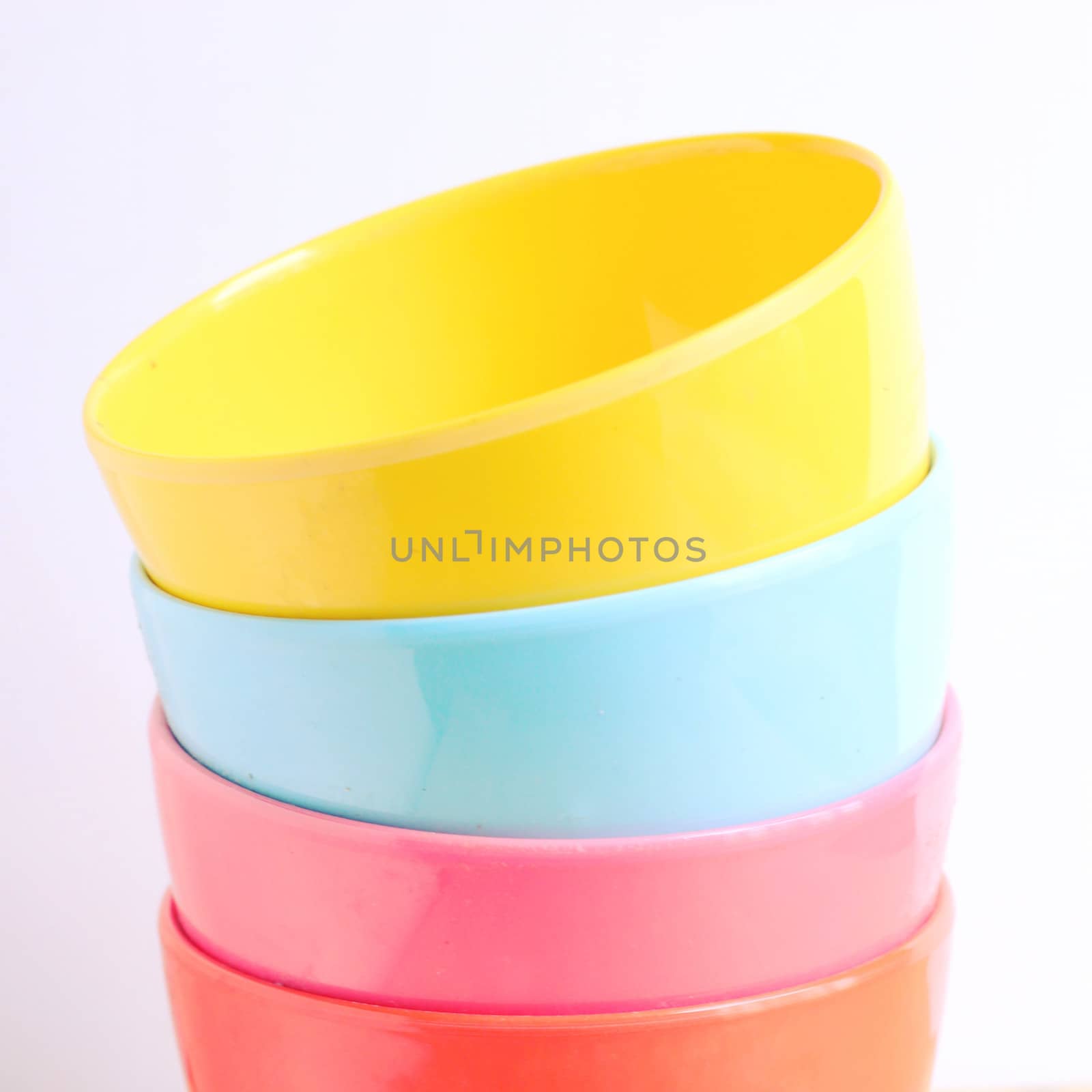 Stack of colorful plastic bowl with retro filter effect by nuchylee