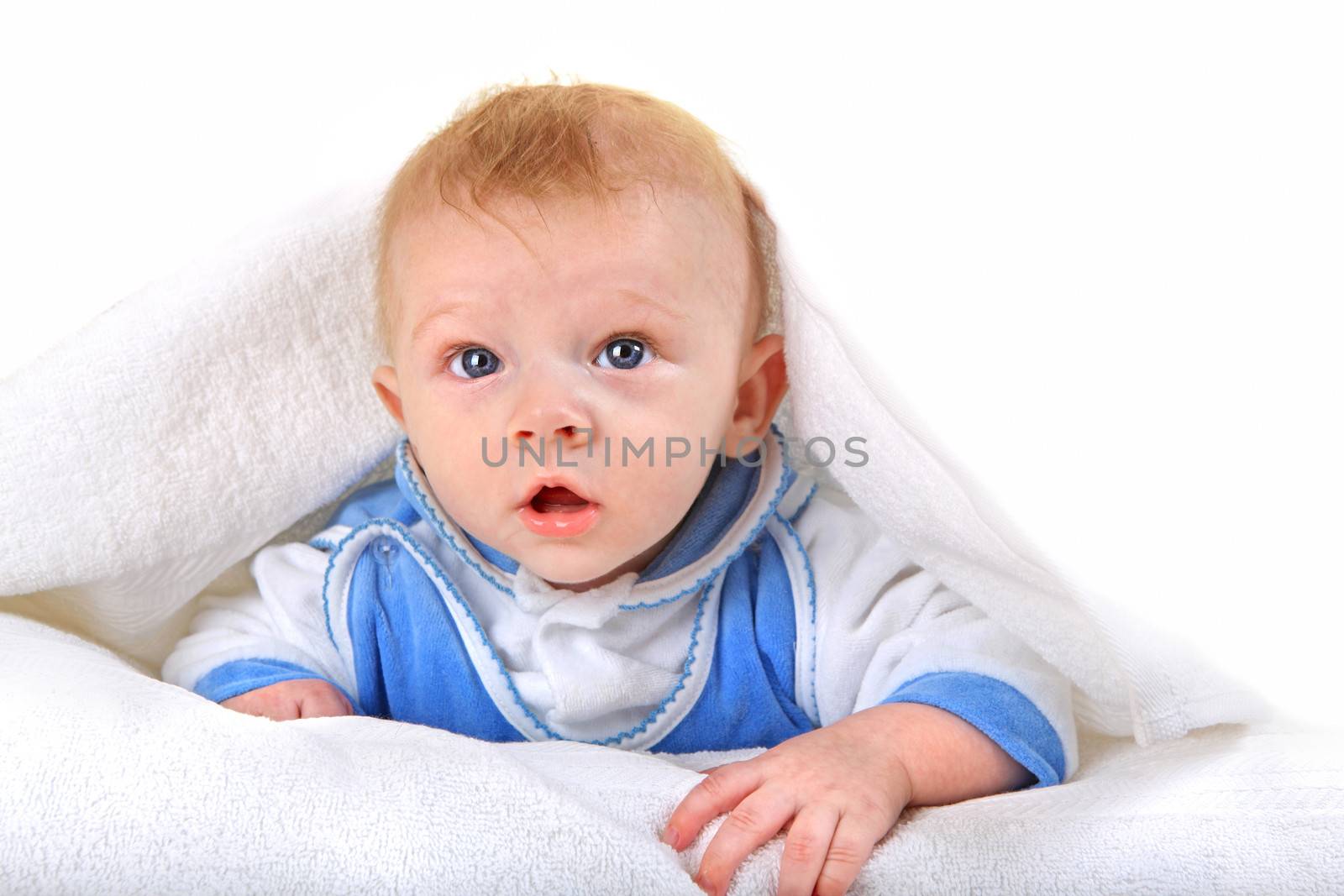 Surprised Baby Boy lying on the White blanket