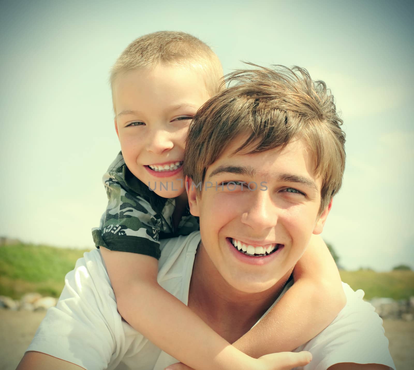 Vintage photo of happy teenager and kid outdoor