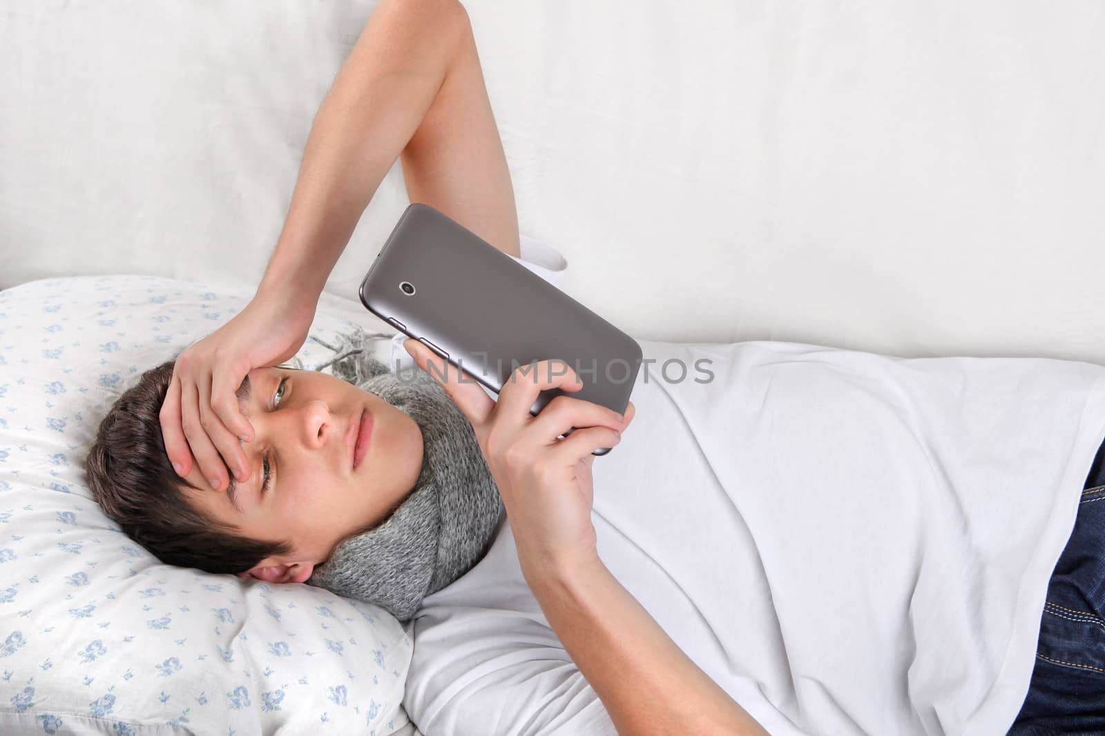 Young Man with Tablet Computer on the bed