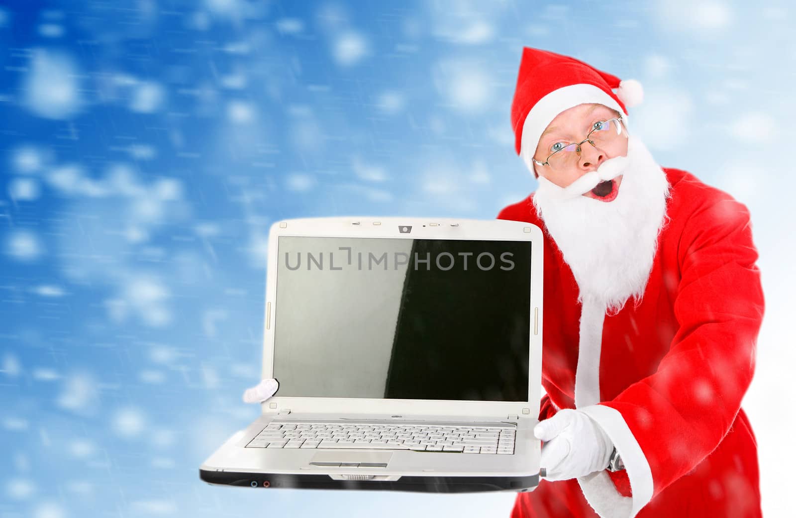 Surprised Santa Claus with Laptop on the Abstract Winter Background