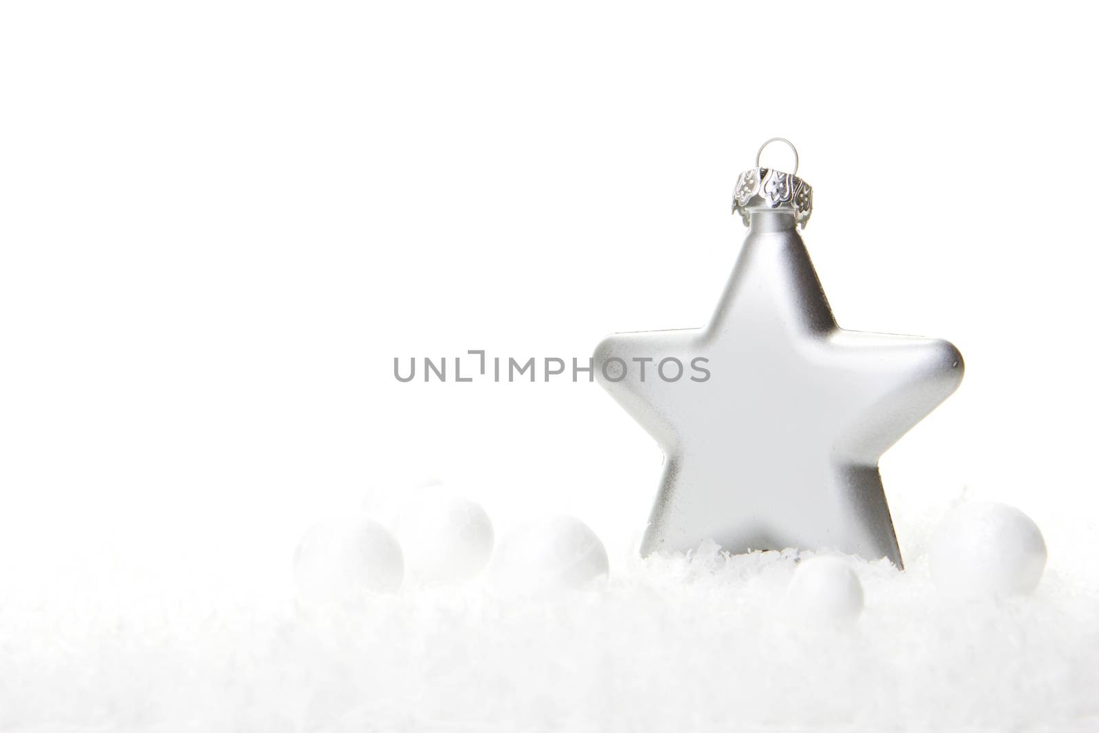 silver christmas bauble as christmas star on snow 