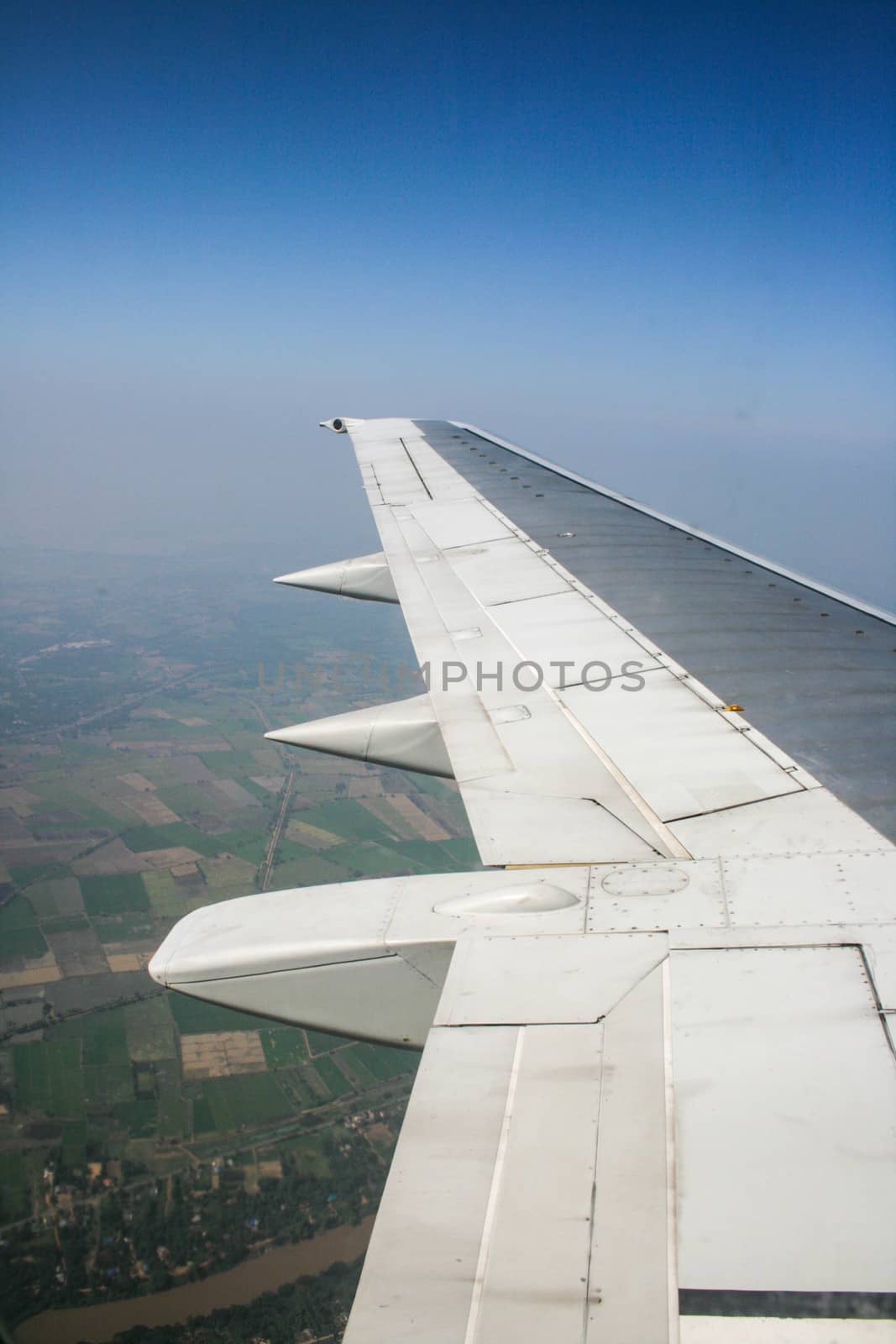 Earth and wing of an airplane flying