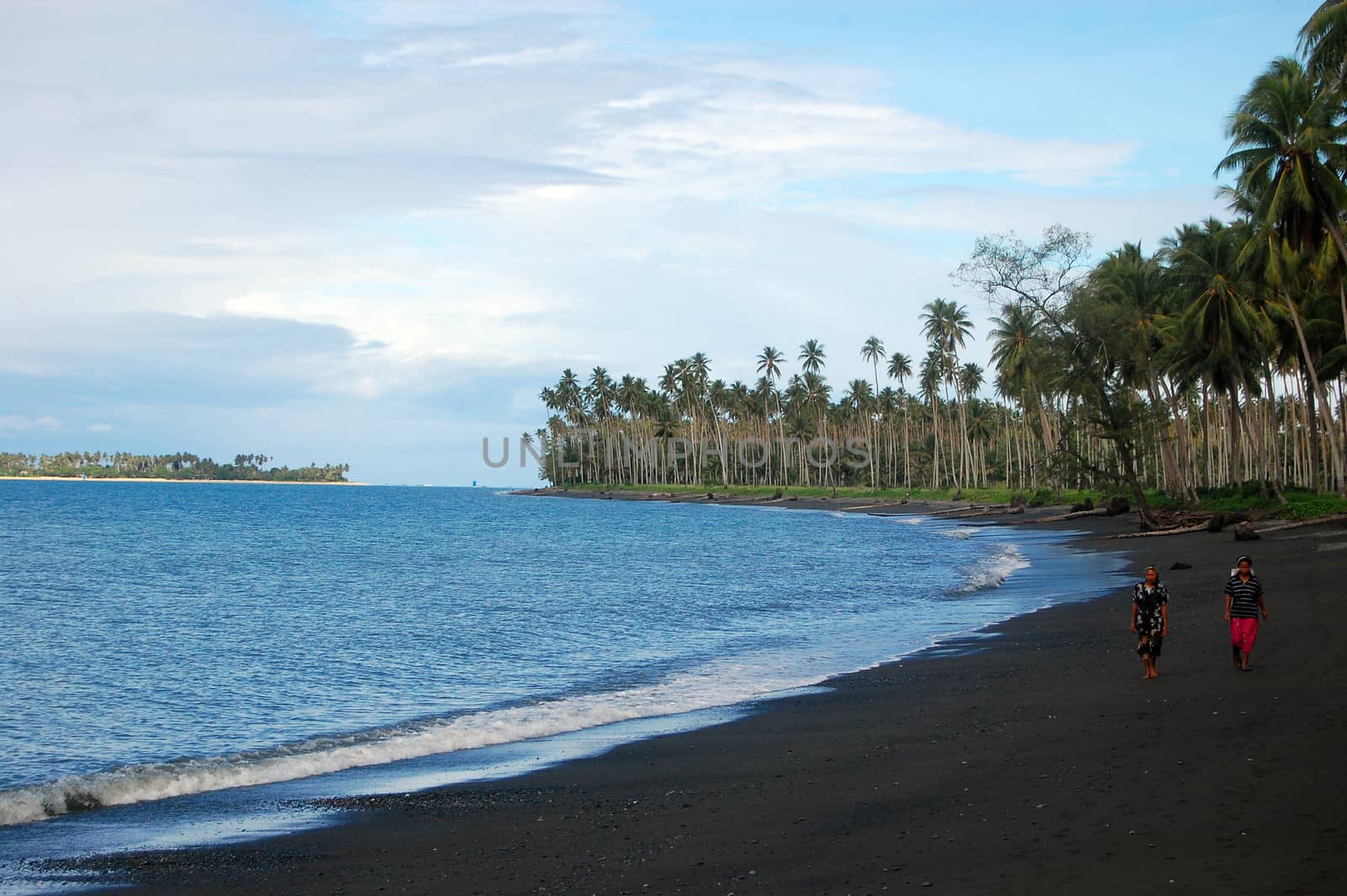 People walk at ocean beach, Papua New Guinea