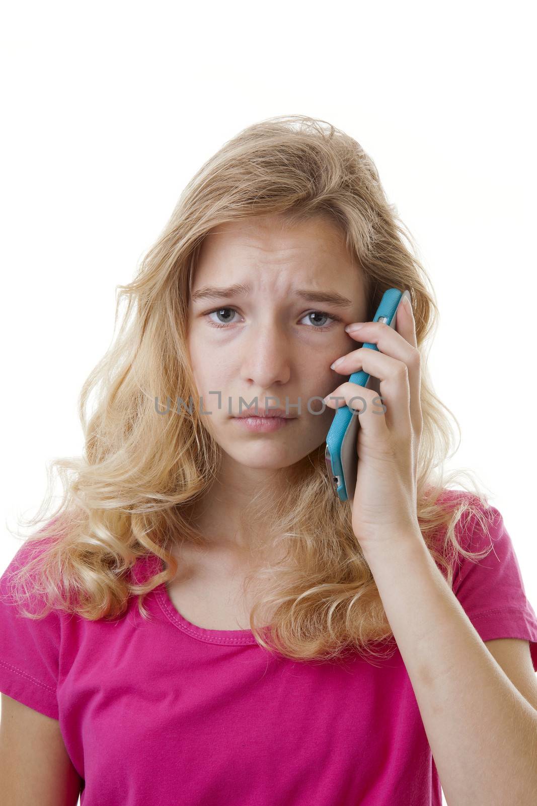 Girl is calling on mobile phone over white background looking sad