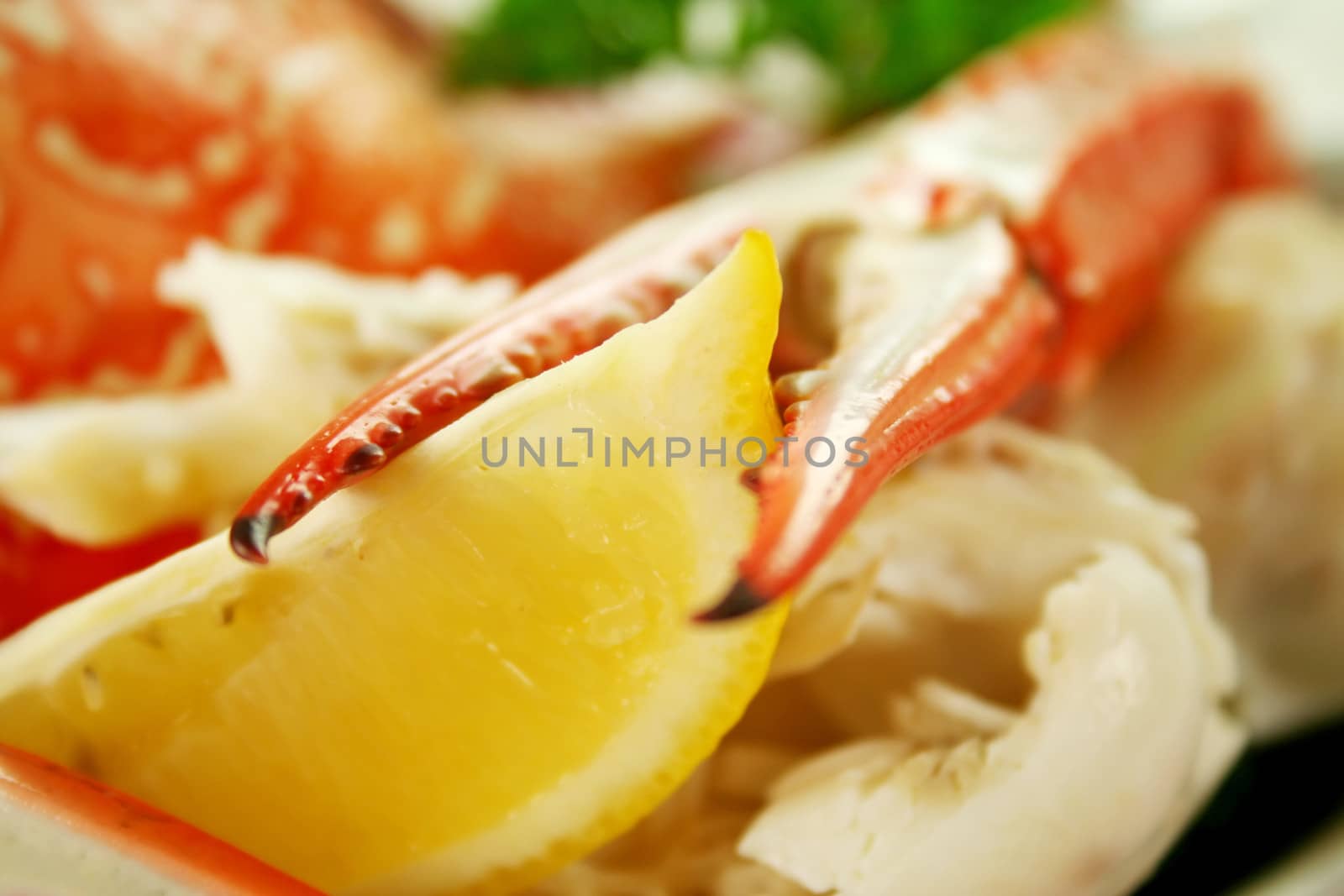 Cracked sand crab claw with lemon ready to serve.