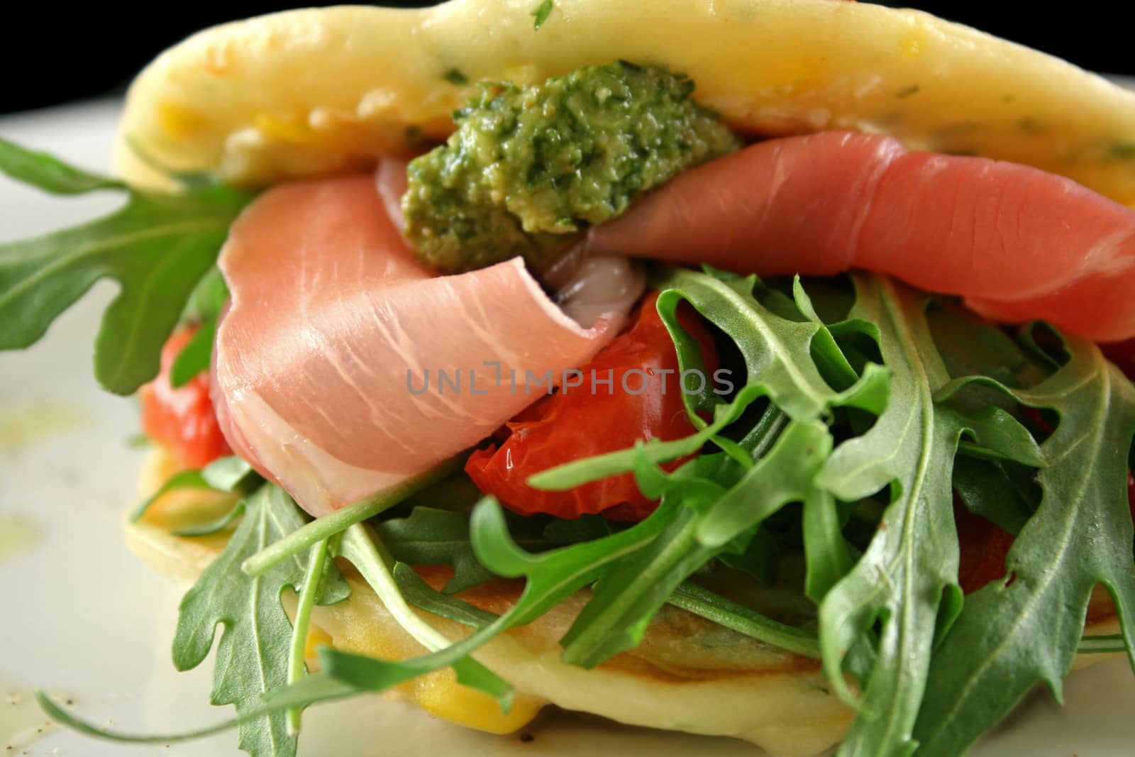 Corn fritters with prosciutto, sundried tomatoes and pesto.