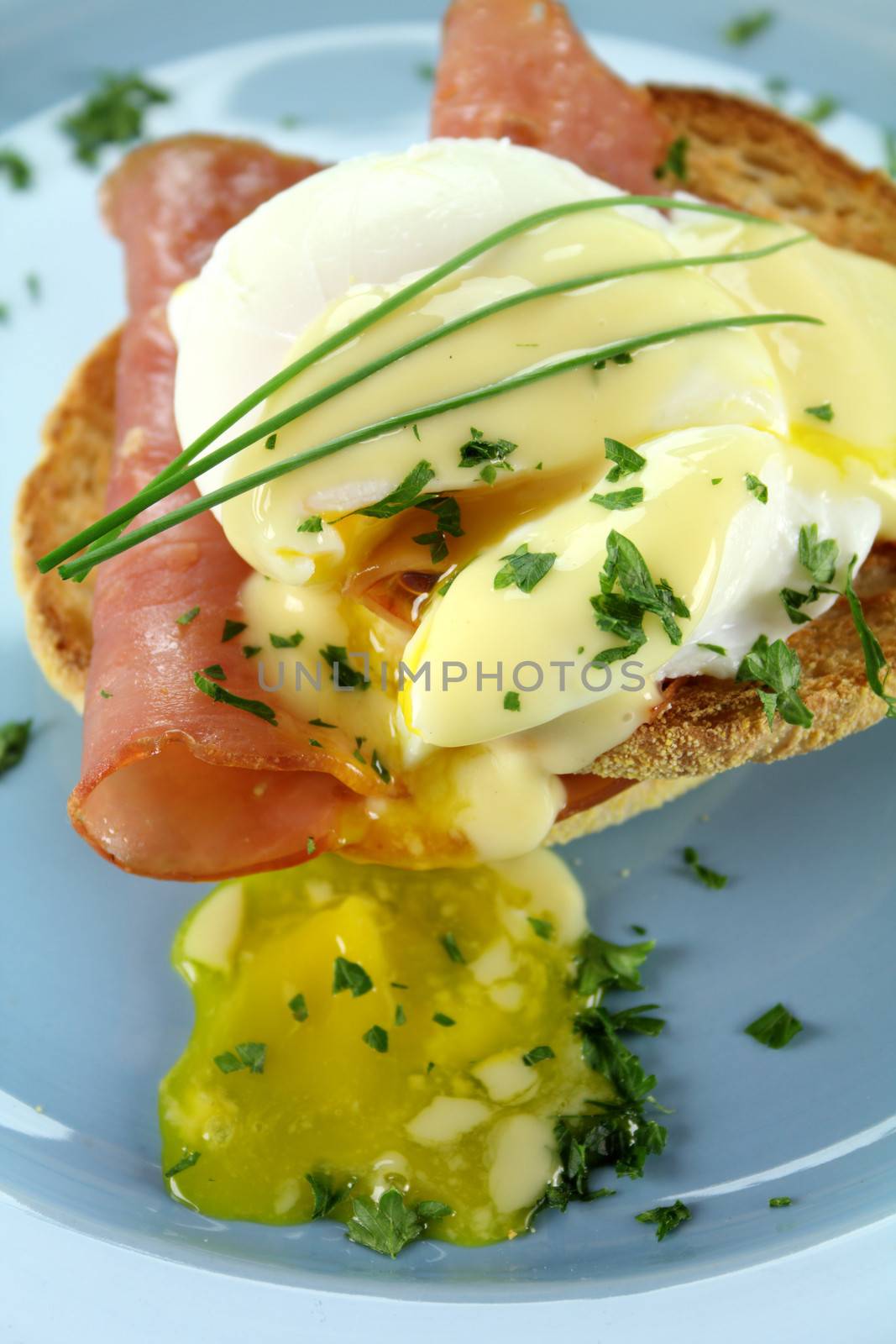 Delicious breakfast of eggs benedict with beautiful rich hollandaise sauce.