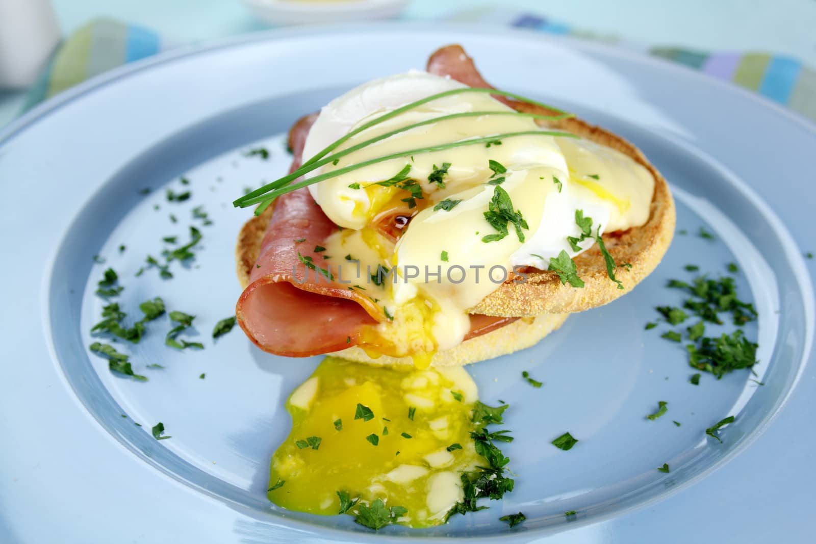 Delicious breakfast of eggs benedict with beautiful rich hollandaise sauce.