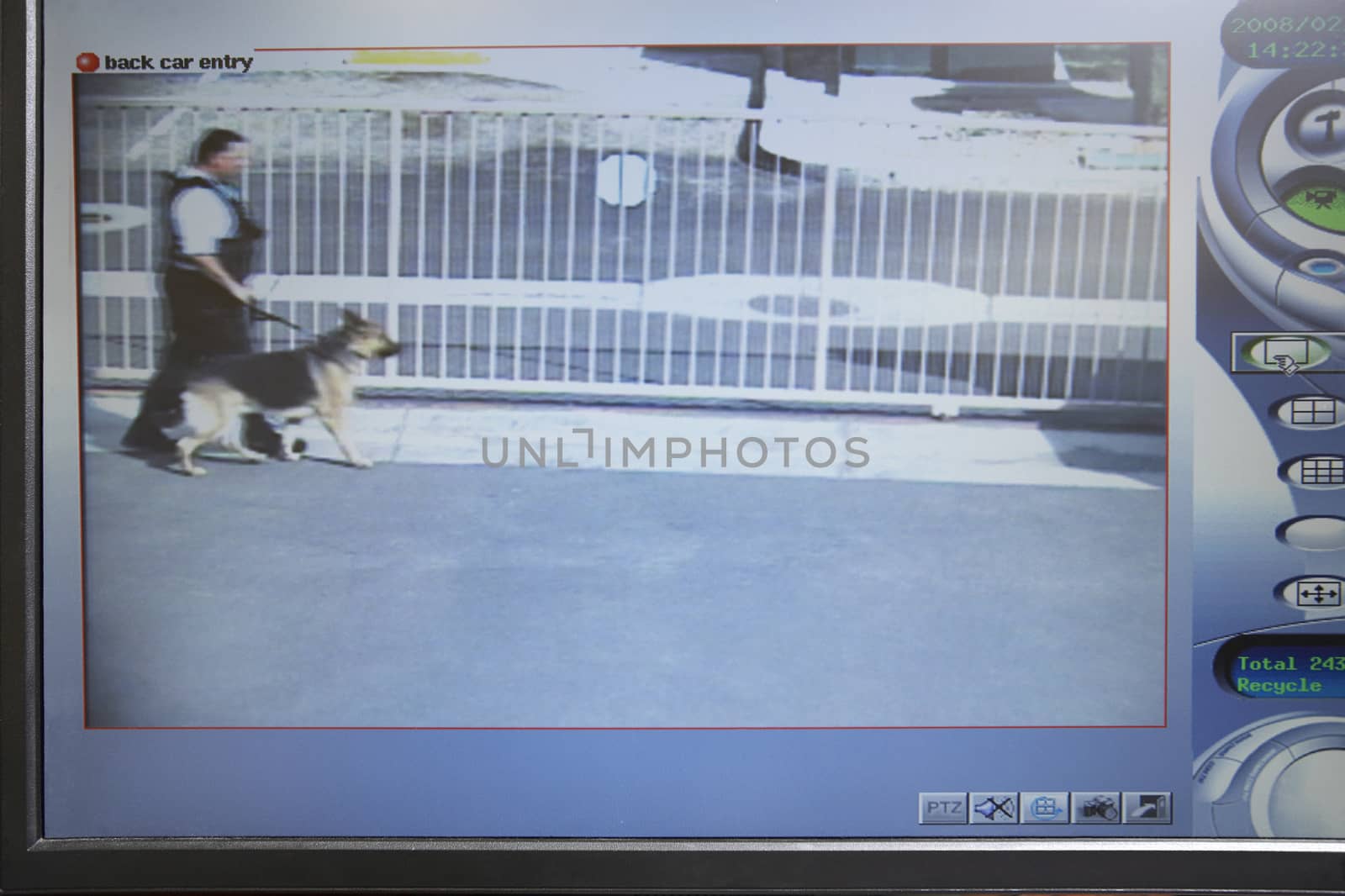 Video monitor with picture from security camera showing a guard with dog by moodboard
