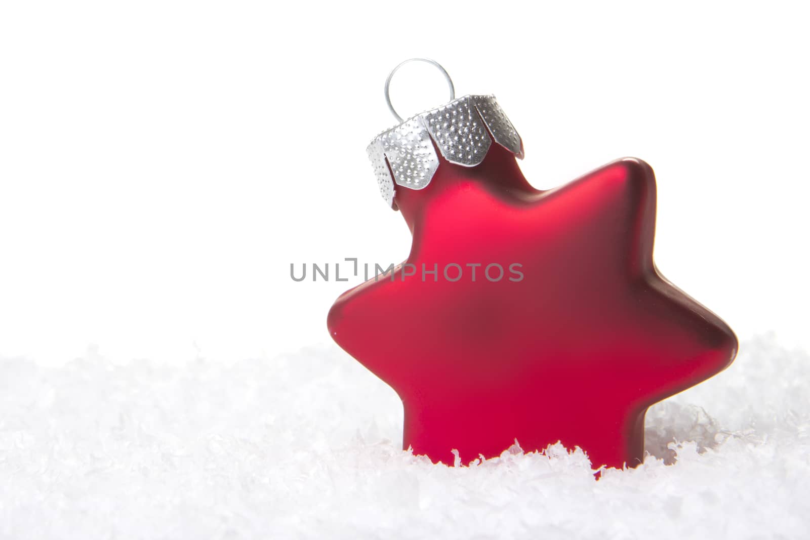 red christmas bauble as christmas star on snow