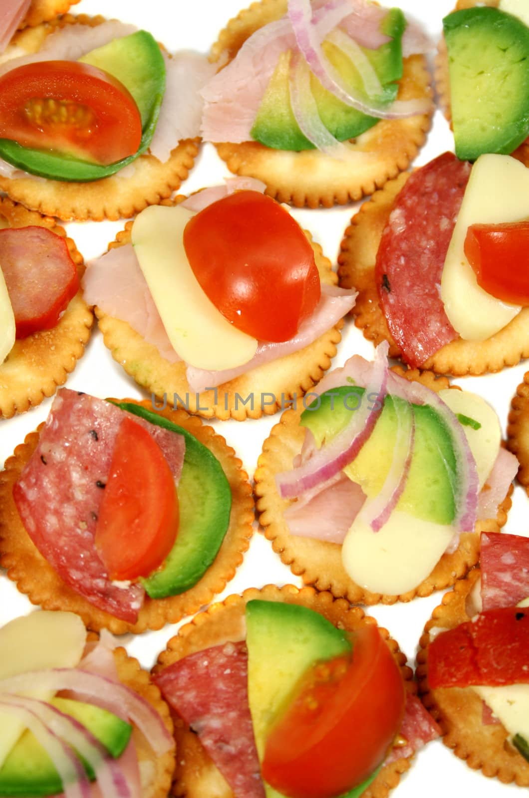 Finger food of cracker biscuits with various toppings.