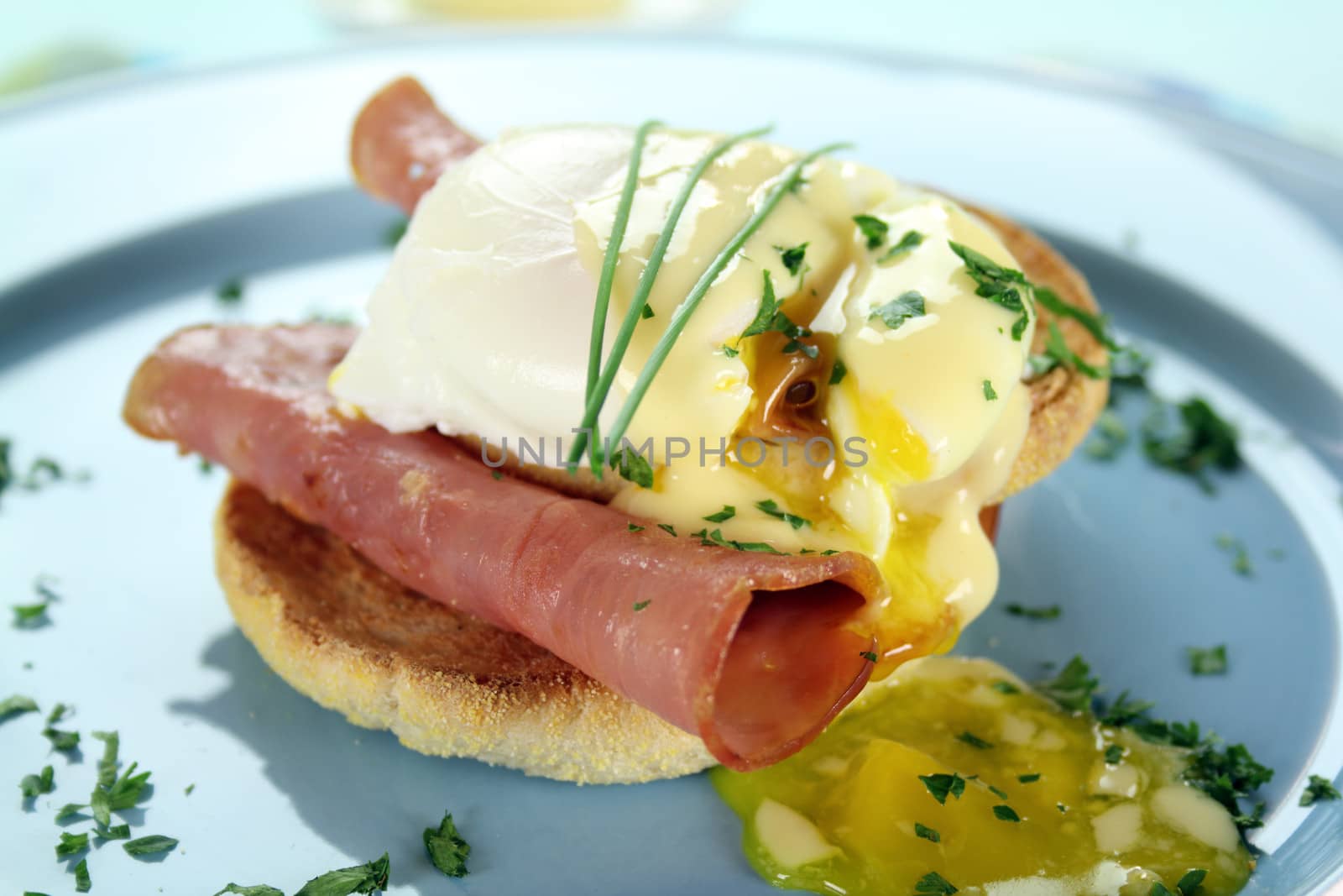 Delicious breakfast of eggs benedict with beautiful rich hollandaise sauce.