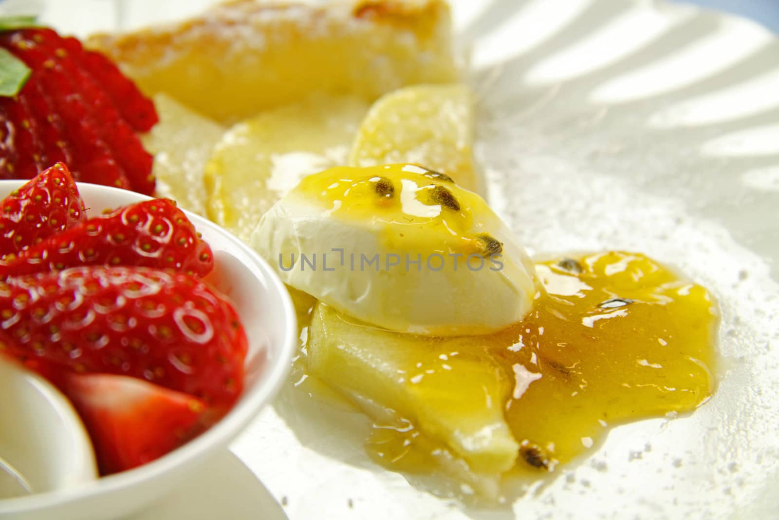 Delicious flat apple pie with strawberries and passionfruit cream.