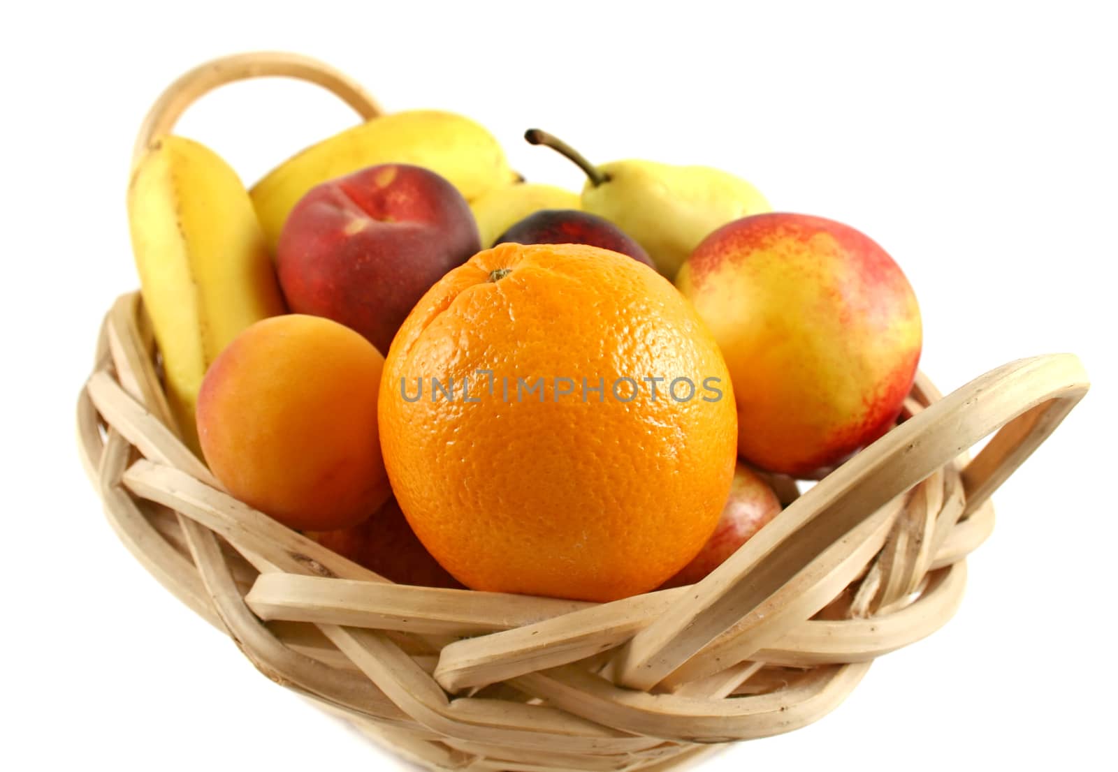 Cane basket filled with freshly picked colorful organic fruit.