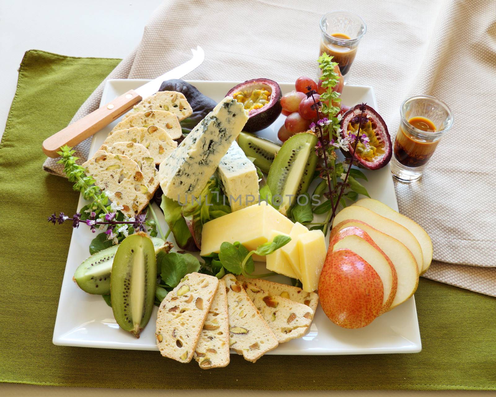Delicious fruit and cheese platter featuring a variety of different cheeses and fresh fruits.