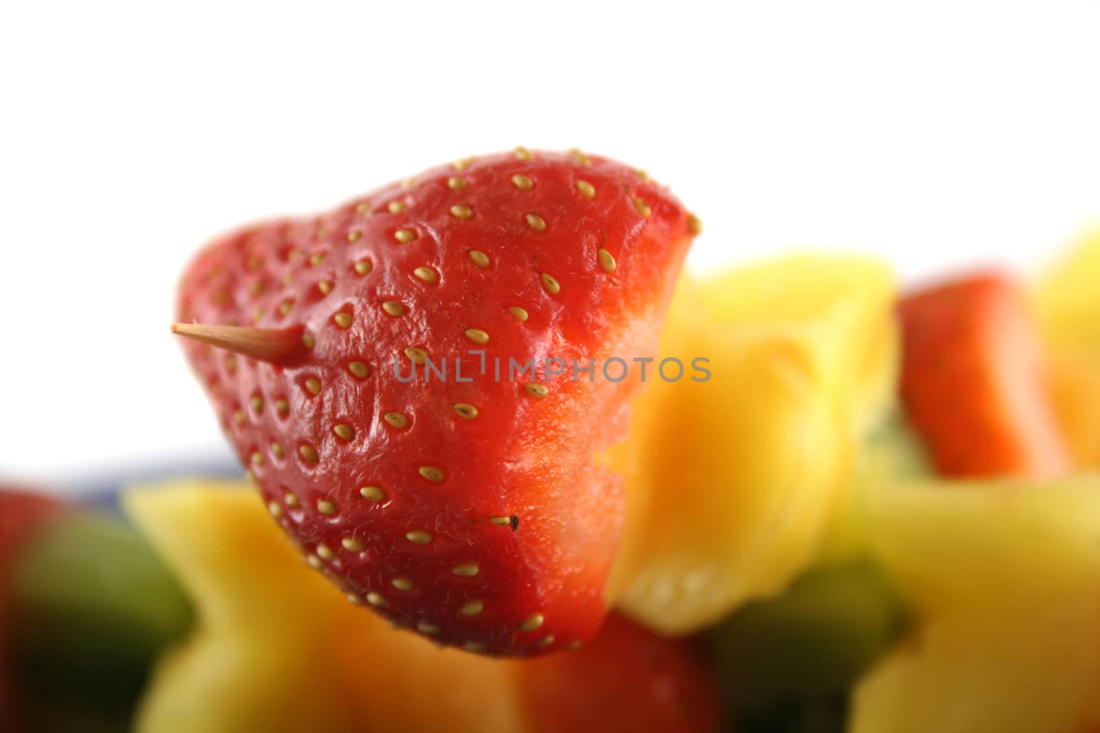 Colorful kebabs made with skewers of fresh fruit pieces.