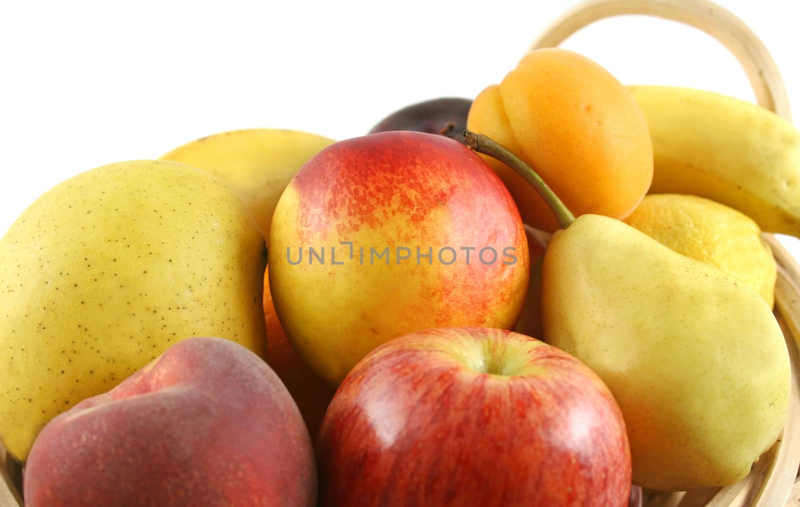 Cane basket filled with freshly picked colorful organic fruit.