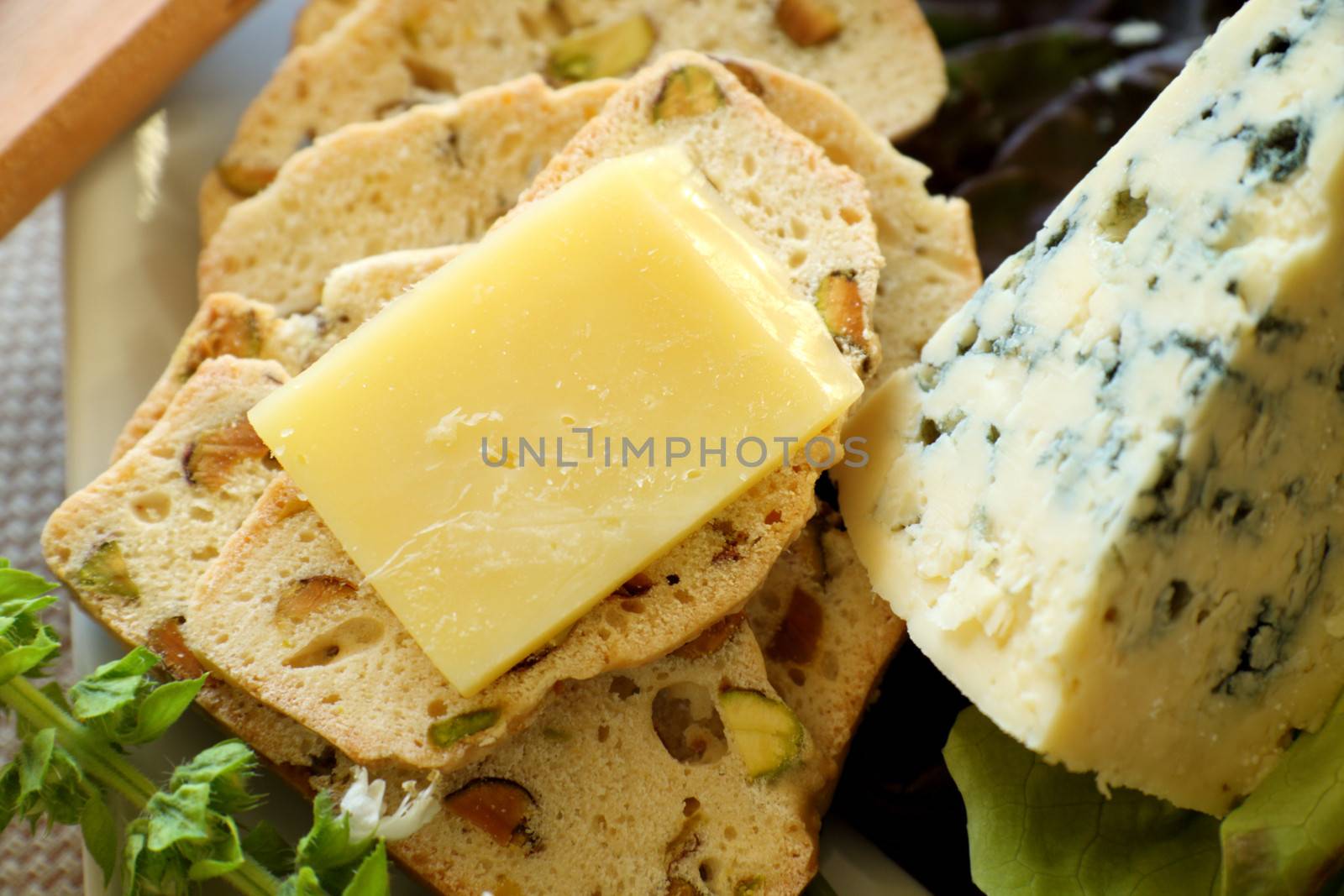 Delicious fruit and cheese platter featuring a variety of different cheeses and fresh fruits.