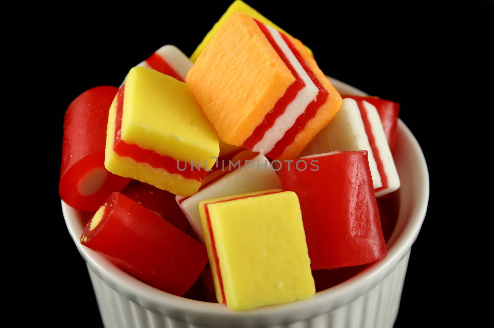 Colorful striped fruit flavored candies ready to eat.