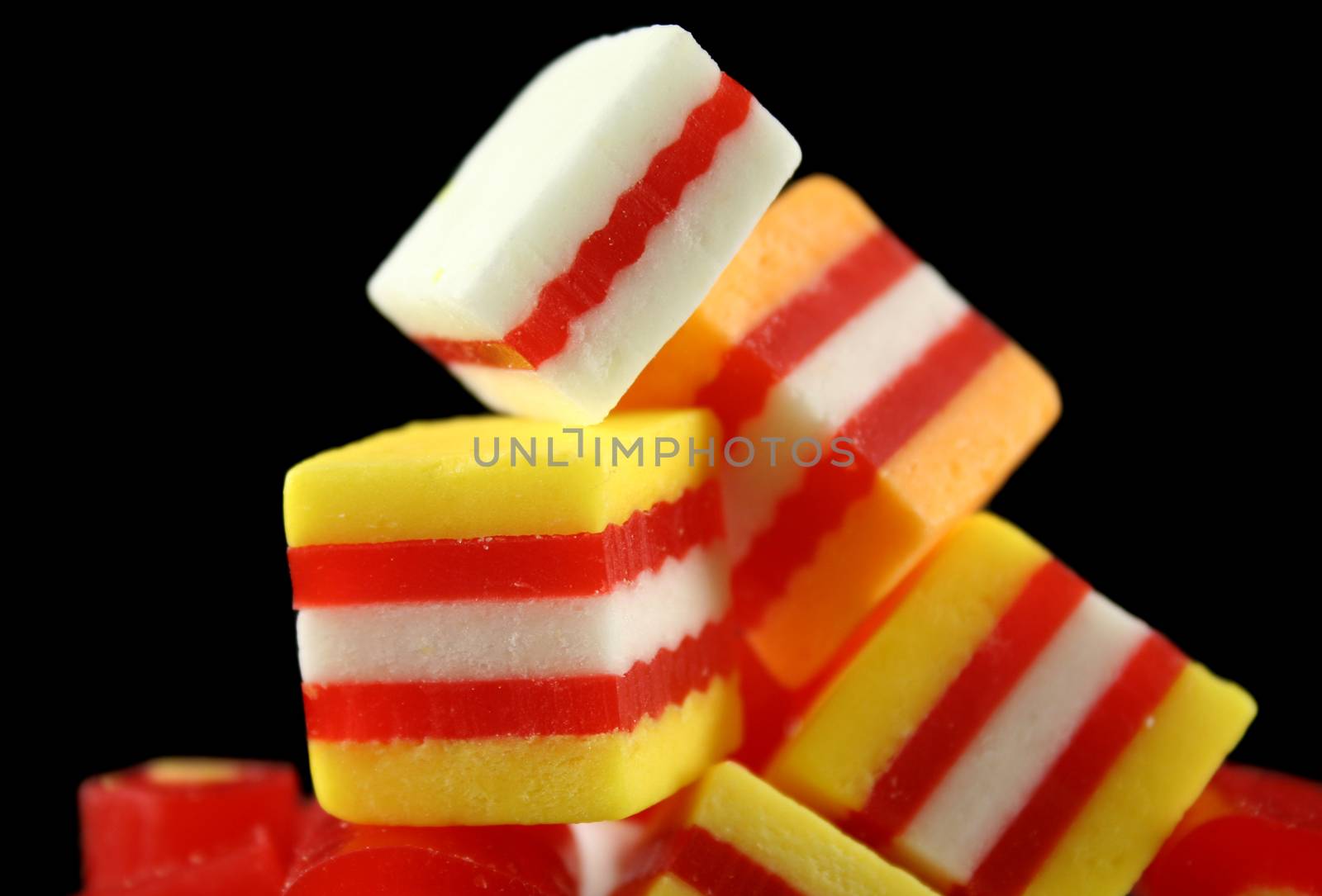 Colorful striped fruit flavored candies ready to eat.