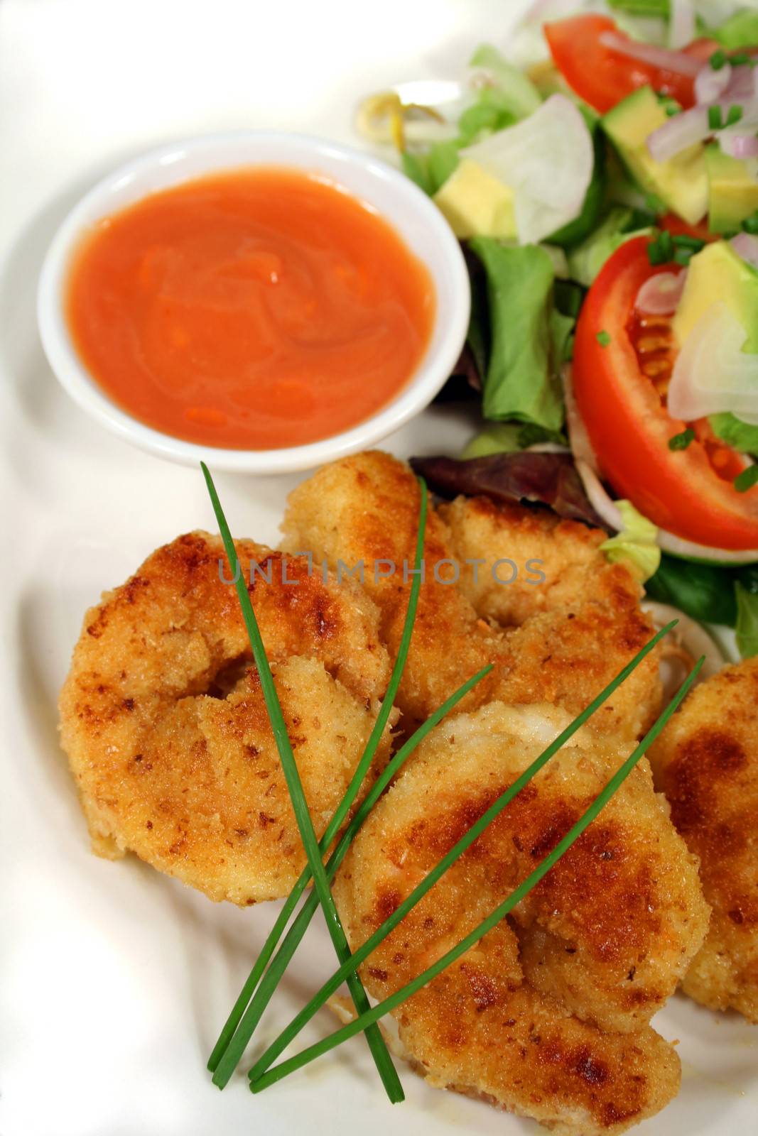 Fried shrimps with dipping sauce and salad.
