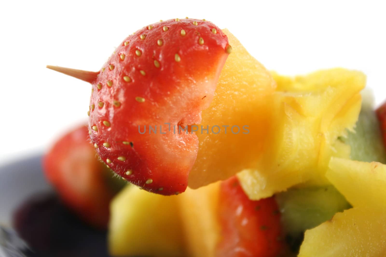 Colorful kebabs made with skewers of fresh fruit pieces.