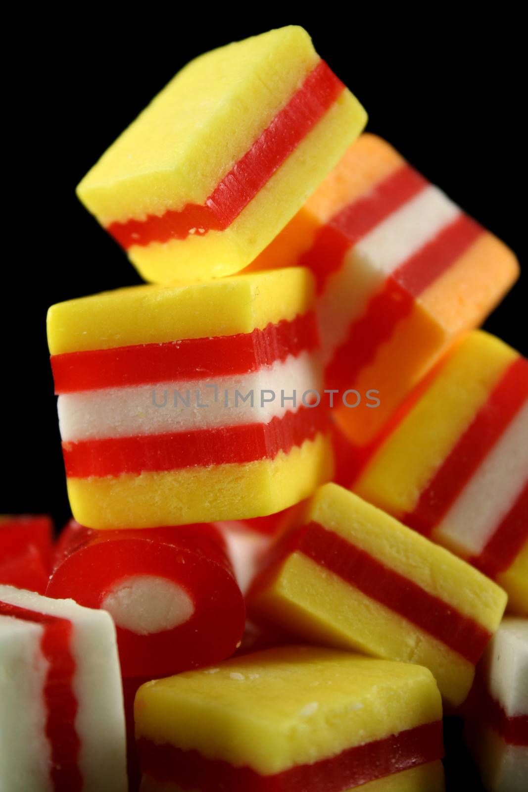 Colorful striped fruit flavored candies ready to eat.

