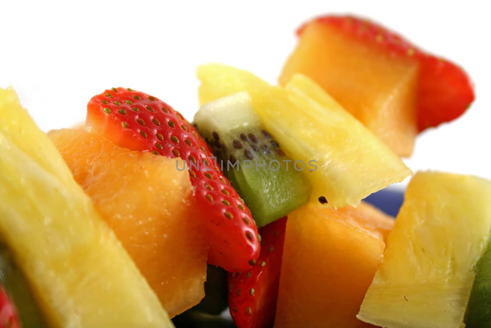 Colorful kebabs made with skewers of fresh fruit pieces.