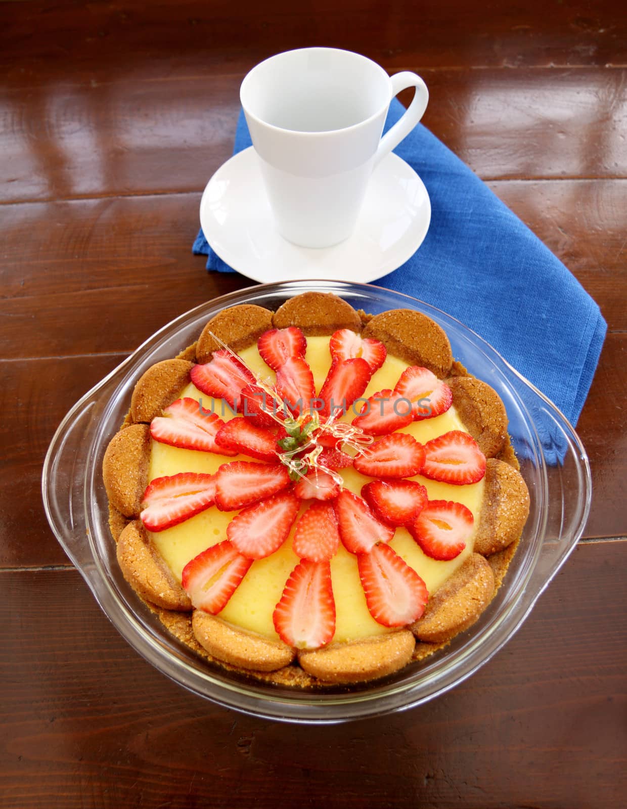 Delightful strawberry custard ginger biscuit tart with toffee garnish ready to serve.