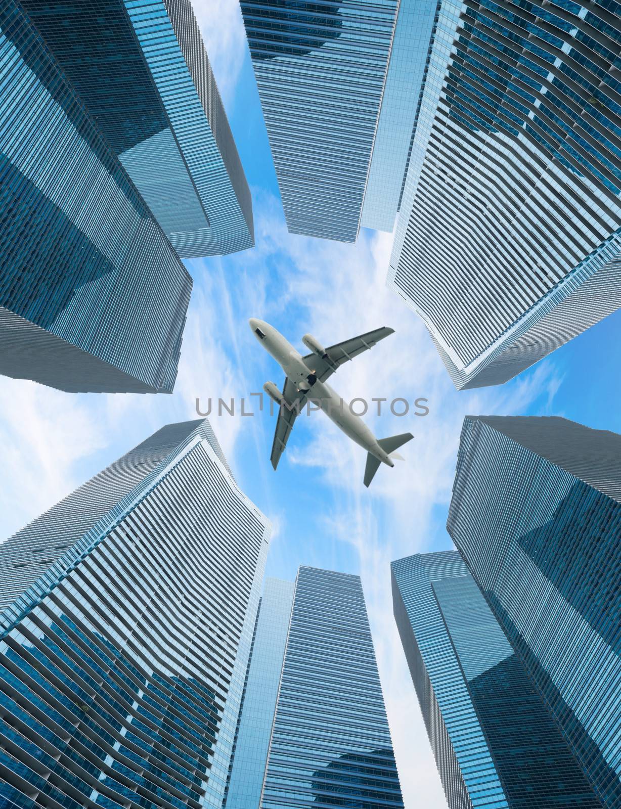 Airplane fly above modern cityblue  skyscrapers 