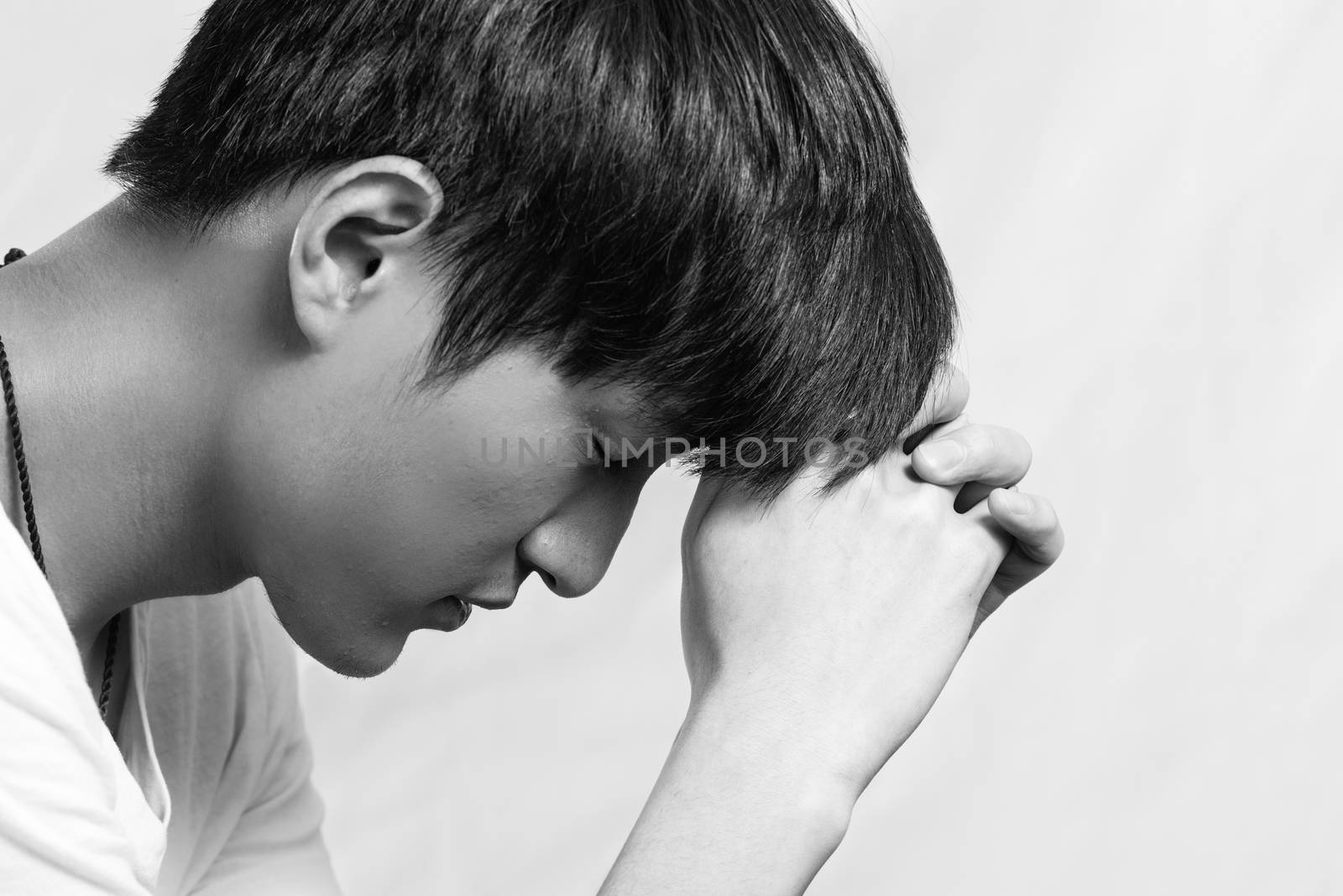 Young man looking depressed by IVYPHOTOS