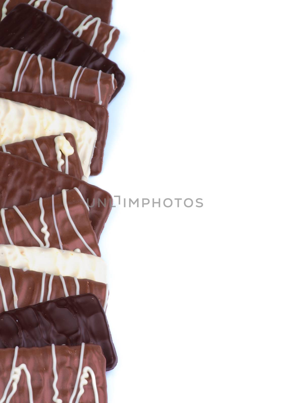 Frame of Milk, Dark and White Chocolate Blocks with Striped Glaze isolated on white background