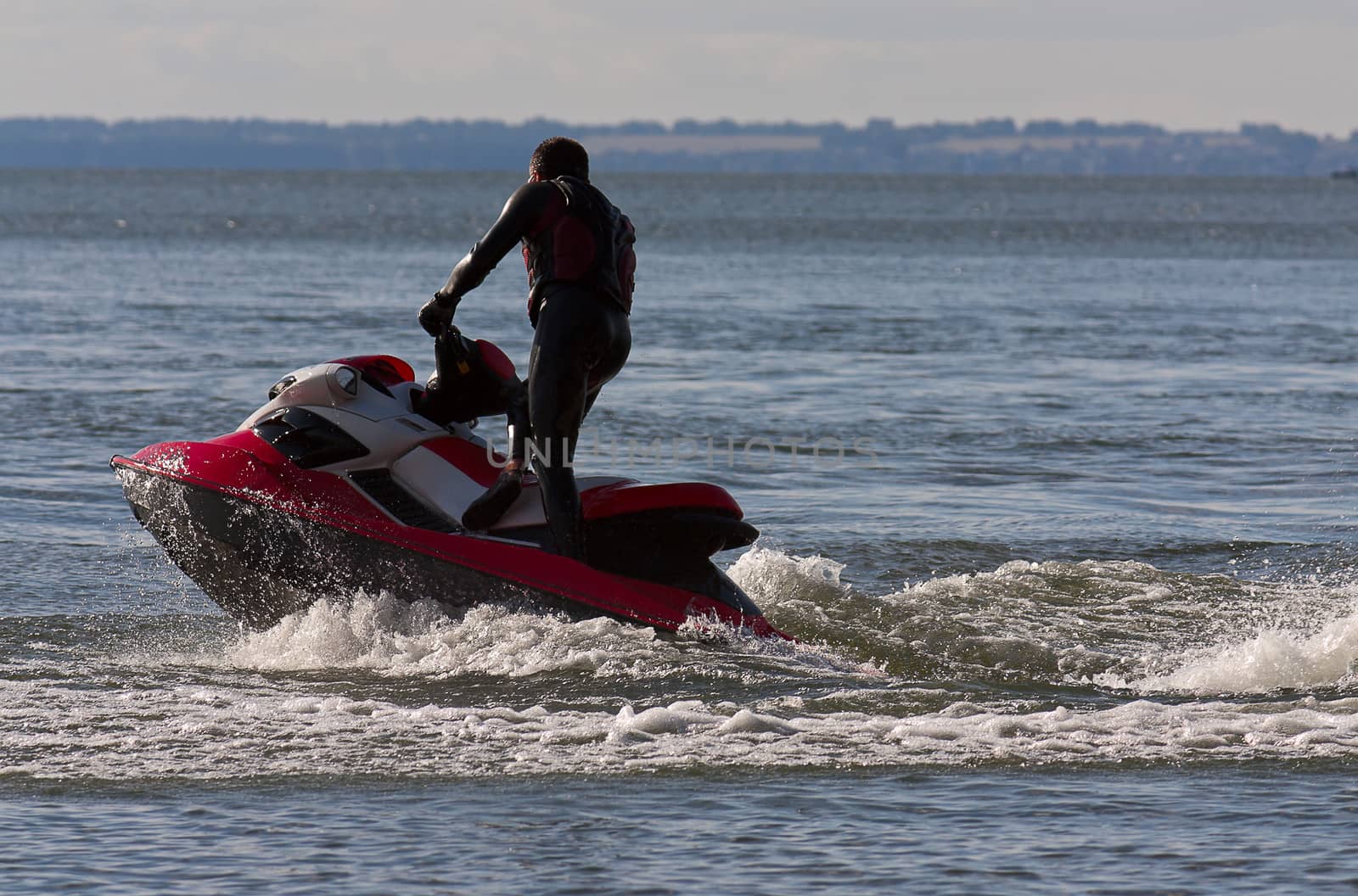 This is  man on  jet ski in  sea close-up.