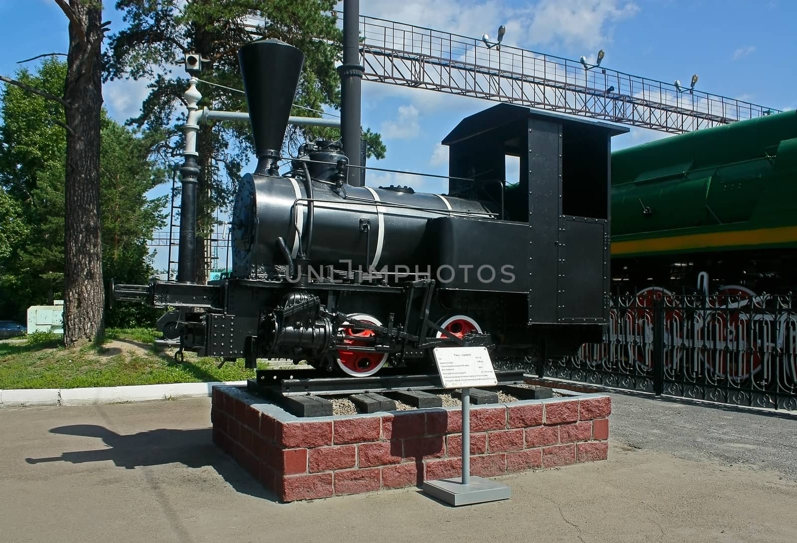 Locomotive with  steam engine is on  rails as  museum piece.