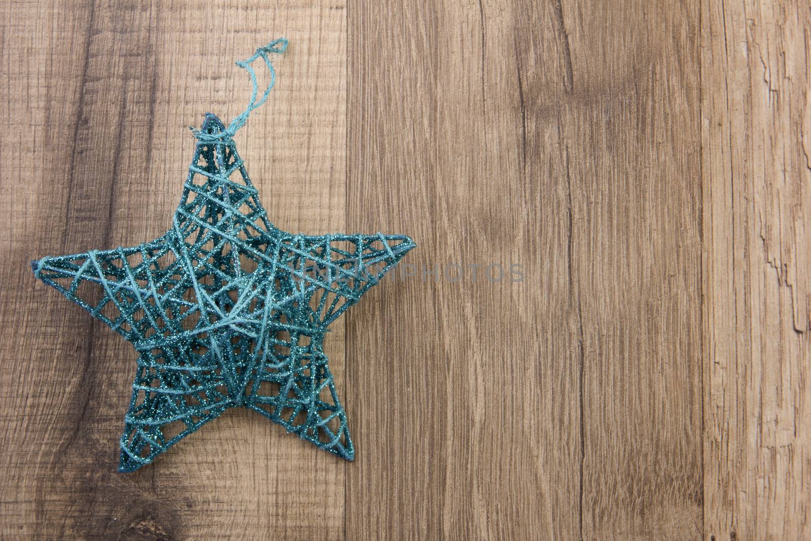 Christmas decoration with wood background, Christmas star turquoise 
