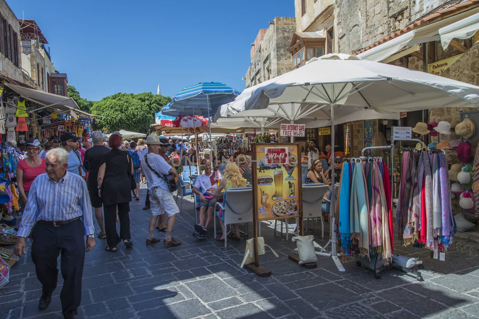 busy street in the old town of rhodes by steirus